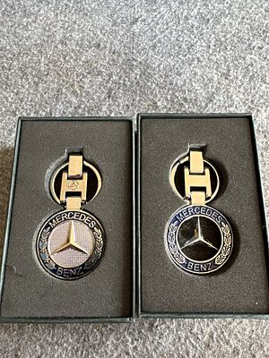 A Pair of Mercedes-Benz Blue Enamel and Silver-Tone Keychains in Original Boxes. This lot 