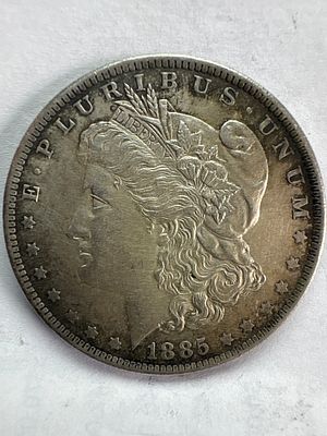 US 1885-O Morgan Silver Dollar. This coin is composed of 90% silver and 10% copper. The obverse 