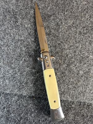 Modern Automatic Stiletto Style Folding Knife with Synthetic Scales. A modern automatic folding 