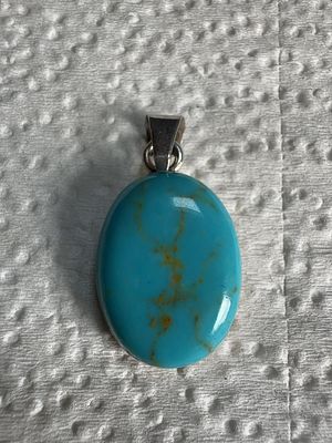 Sterling Silver and Oval Turquoise Pendant Stamped RM. A sterling silver pendant featuring a 