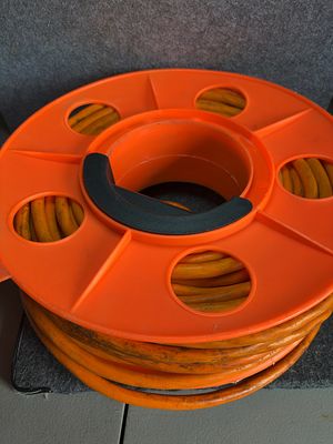 Heavy-Duty 12/3 SJTW Extension Cord on Orange Storage Reel, Attributed to Bayco. One heavy-duty 