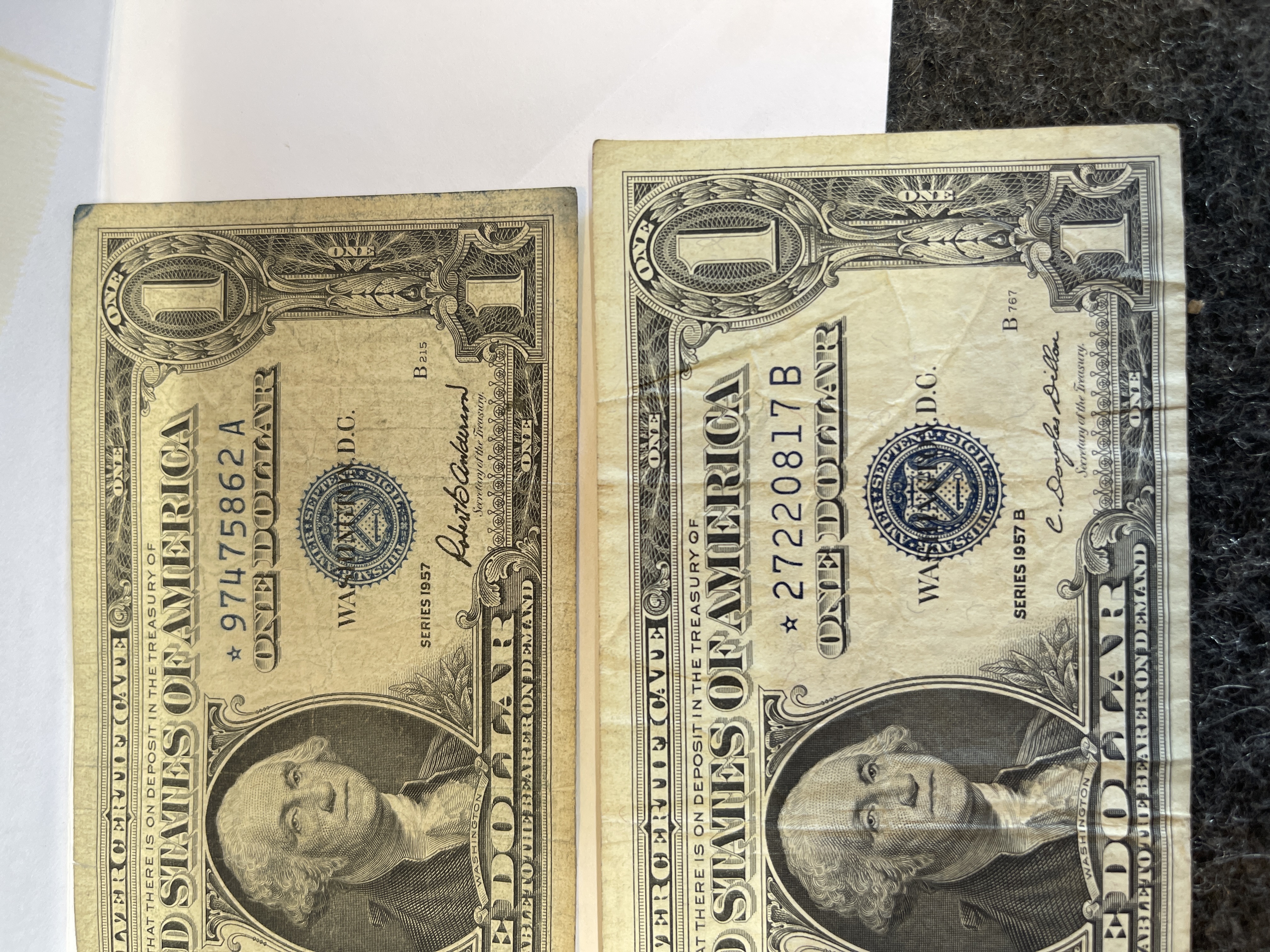 Lot Of 2 - 1957 $1 STAR Note Silver Certificate Blue Seal U.S. One Dollar Bills CONDITION IS FAIR .... THEY HAVE BEEN KEPT PRESSED IN A BOOK