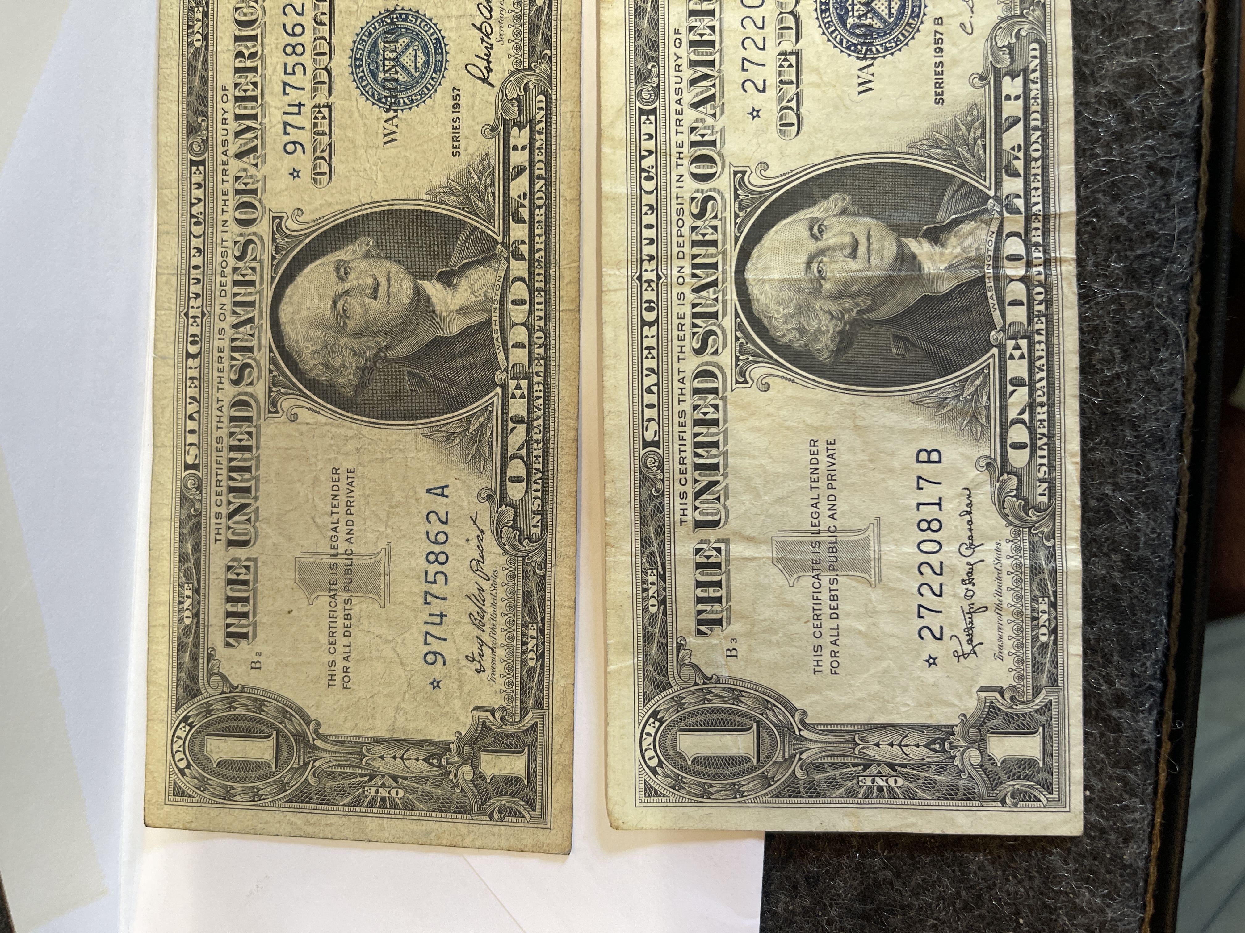 Lot Of 2 - 1957 $1 STAR Note Silver Certificate Blue Seal U.S. One Dollar Bills CONDITION IS FAIR .... THEY HAVE BEEN KEPT PRESSED IN A BOOK