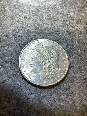 1886 US Morgan Silver Dollar, struck at the Philadelphia Mint. Composition is 90% silver. The 