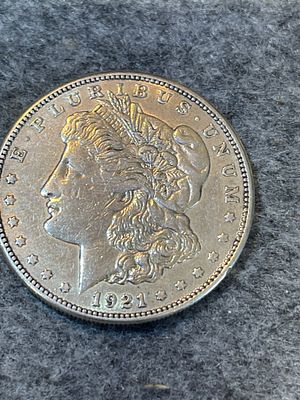 1921-D US Morgan Silver Dollar struck at the Denver Mint. The coin is composed of 90% silver 