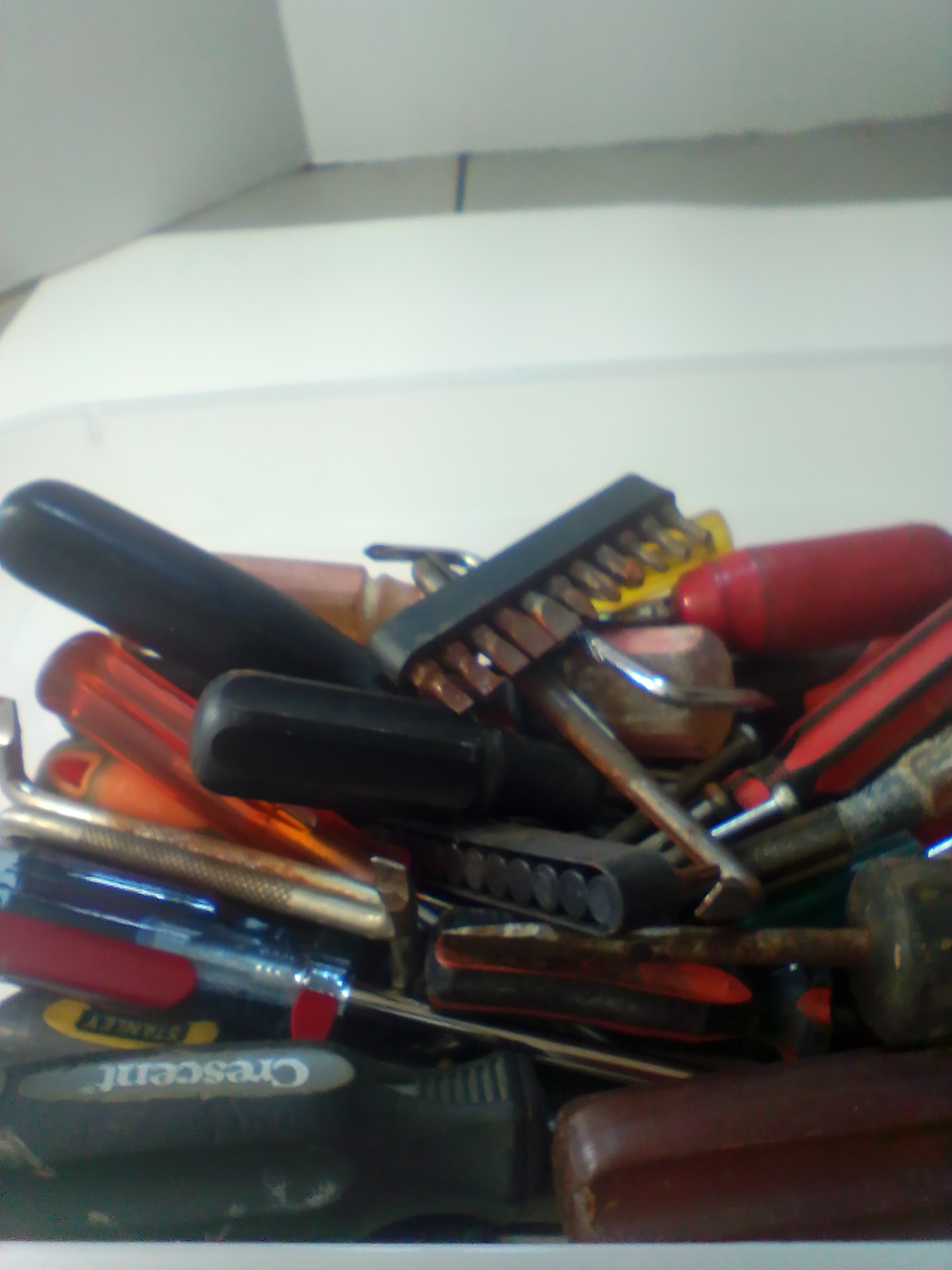 An Assortment of Multi-Brand Hand Tools and Driver Bits in Storage Bin