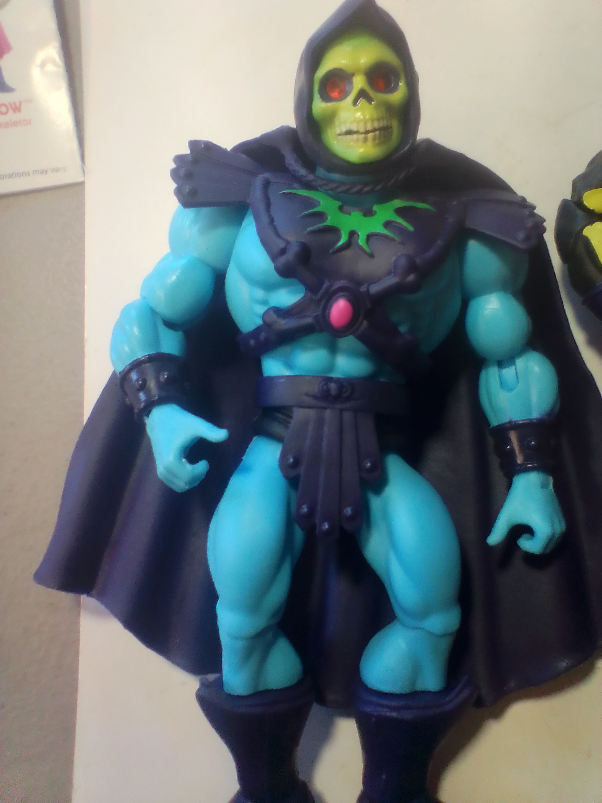 An Assortment of Masters of the Universe Action Figures and Accessories Featuring Skeletor and Scare Glow