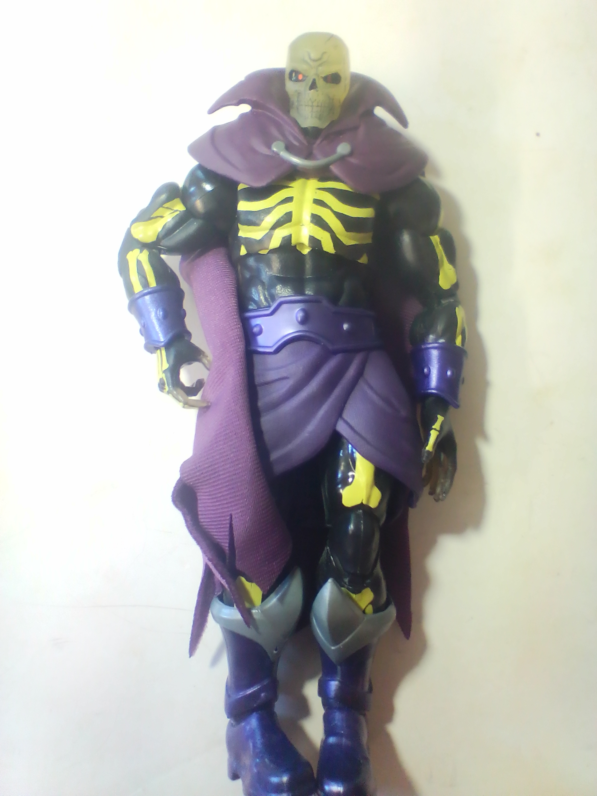 An Assortment of Masters of the Universe Action Figures and Accessories Featuring Skeletor and Scare Glow