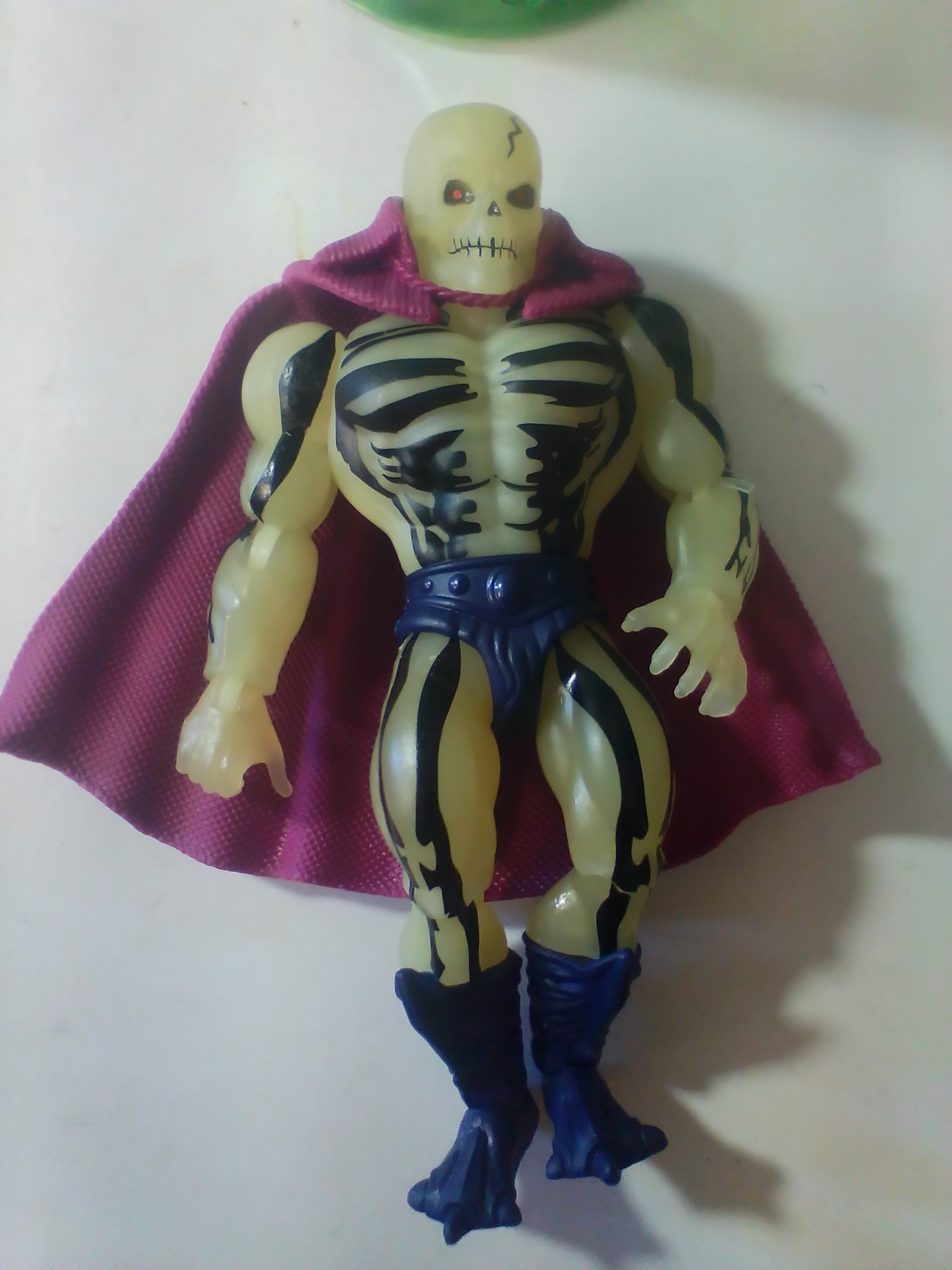 An Assortment of Masters of the Universe Action Figures and Accessories Featuring Skeletor and Scare Glow