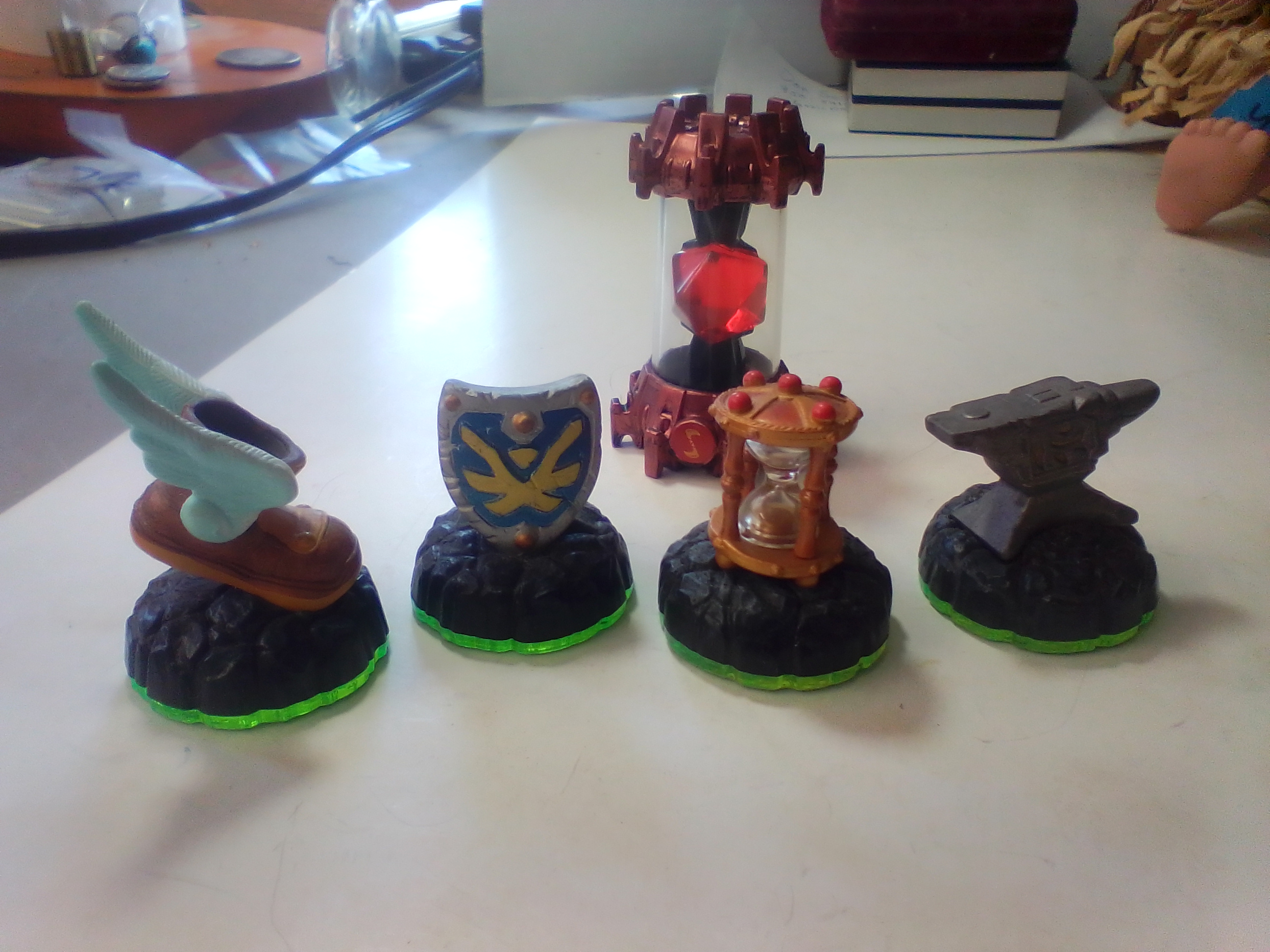 A Collection of Skylanders Interactive Game Pieces and Fire Creation Crystal
