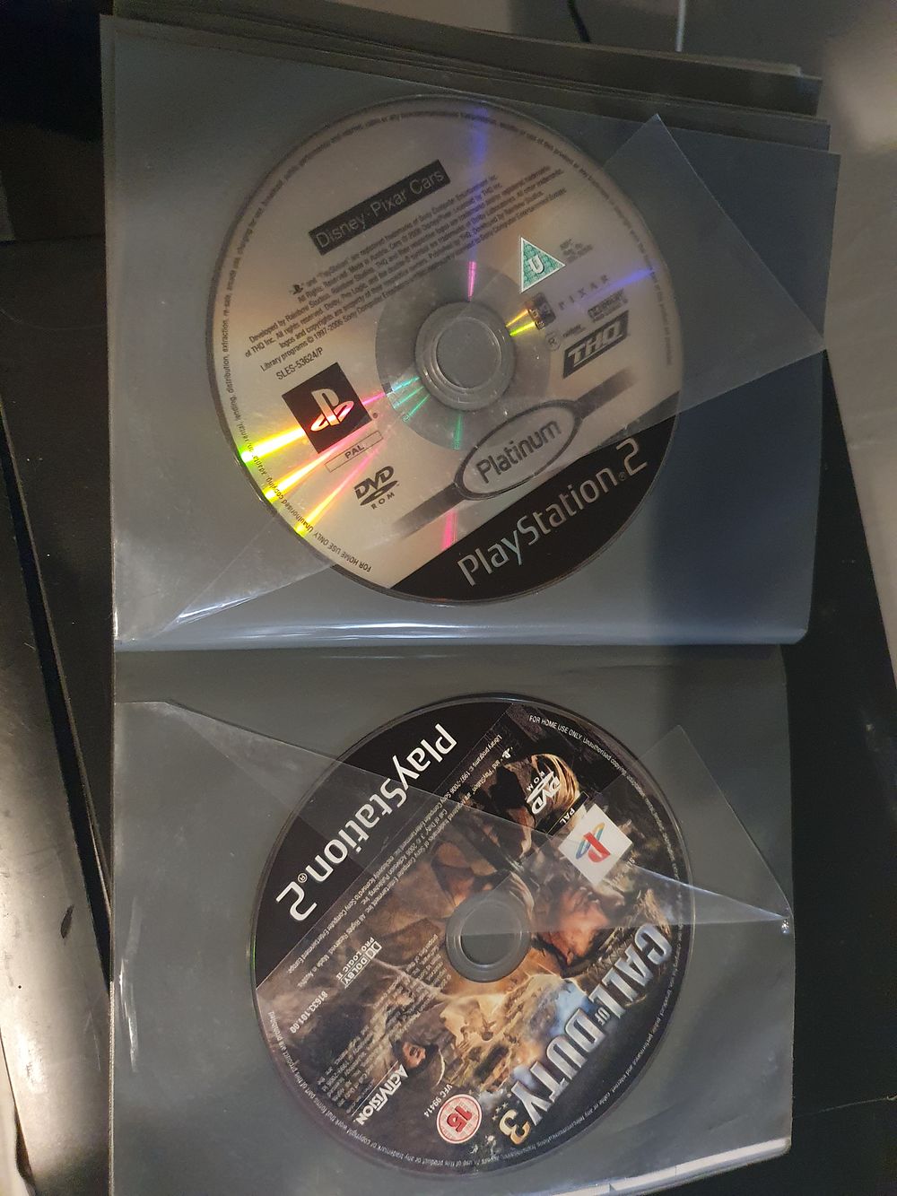 Lot 167: Folder with playstation 2 games in it