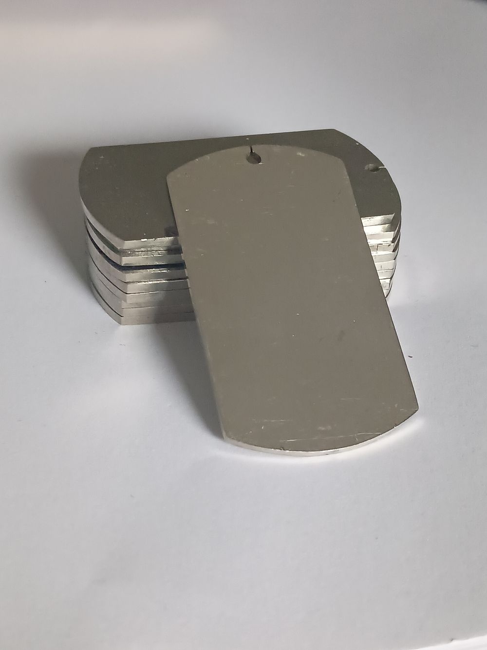 Lot 213: Collection of Solid Engravable Military ID Dog Tags