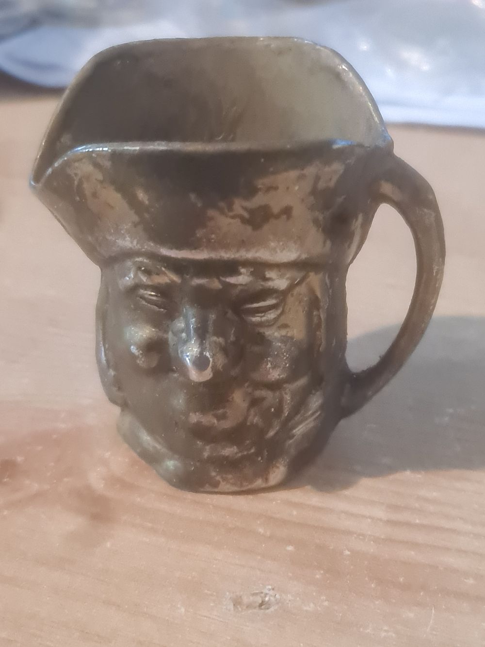 Lot 262: Brass toby jug