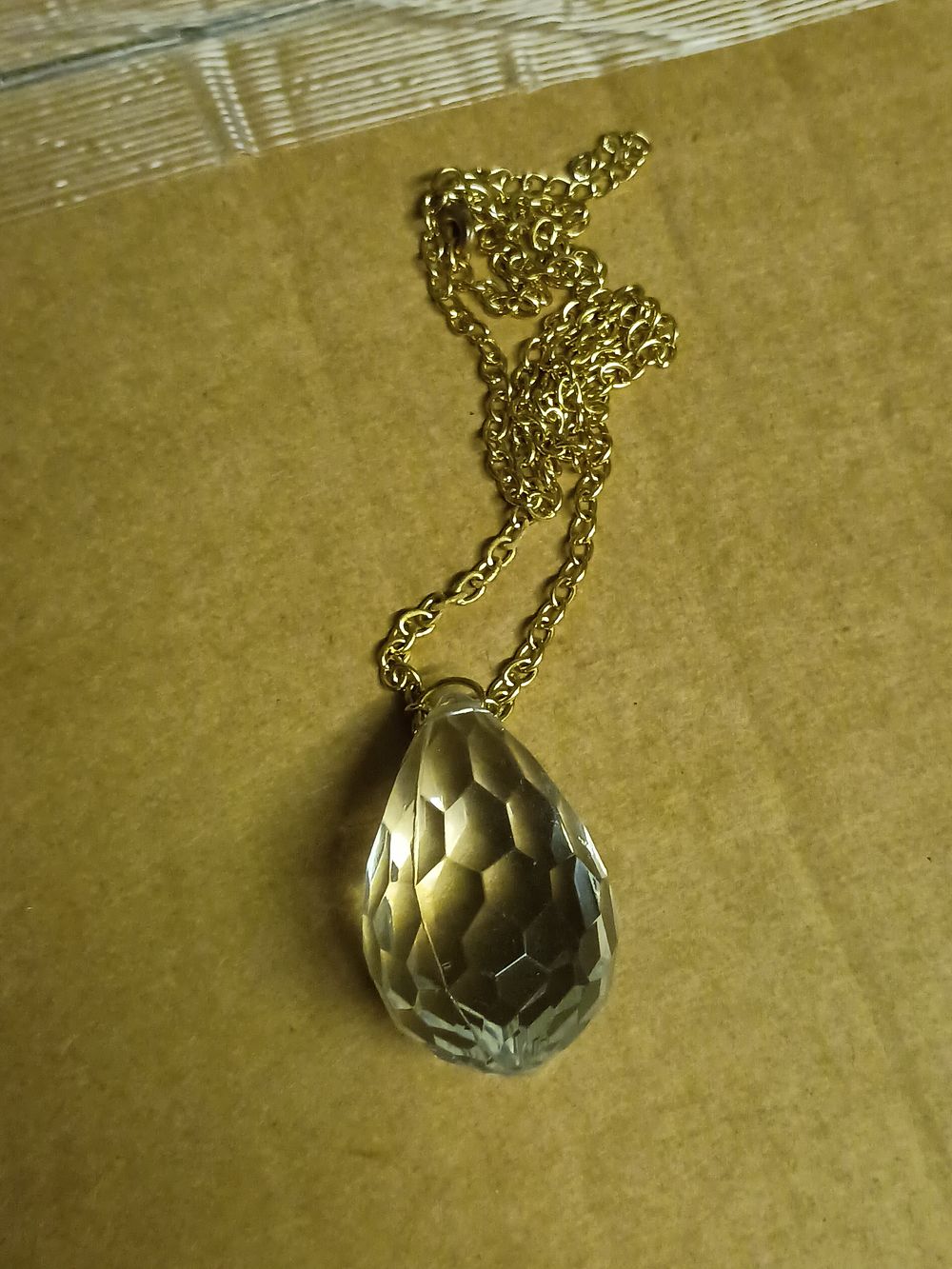 Lot 312: Gold tone chain with large crystal style pendant