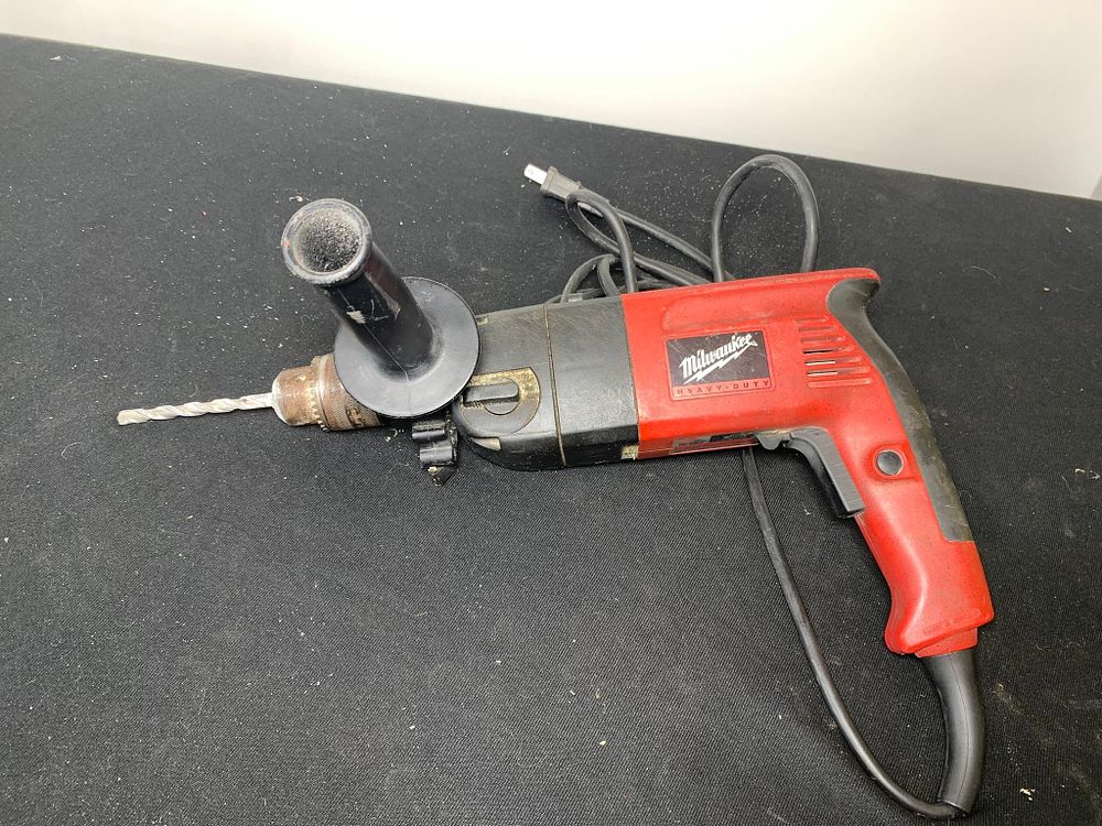 Milwaukee 1/2" Powered Hammer Drill With a Drill Bit. Powers on. Burns in-house shipping is 