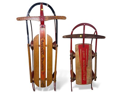 Two Vintage American Steerable Sleds. A pair of vintage steerable sleds, crafted from wood and 