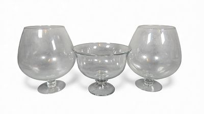 Three Large Clear Glass Footed Vessels, comprising Two Brandy Snifters and One Footed Bowl. This 