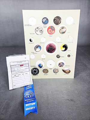 A Collection of Award-Winning Paisley and Monad Motif Buttons. A collection of buttons featuring 