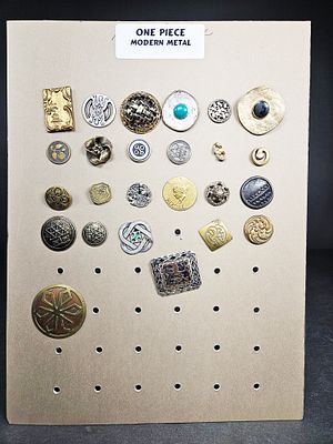 An Assortment of Vintage and Modern Metal Buttons. An assortment of buttons crafted from various 