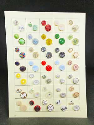 A Collection of Early Celluloid and Glass Buttons on a Display Card. A collection of early 