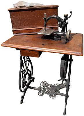 Victorian Willcox and Gibbs Treadle Sewing Machine in Walnut Cabinet. This Victorian-era 
