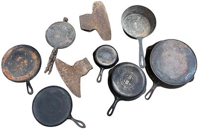 An Assortment of Vintage American Cast Iron Cookware and Axe Heads Including Griswold, Wagner 