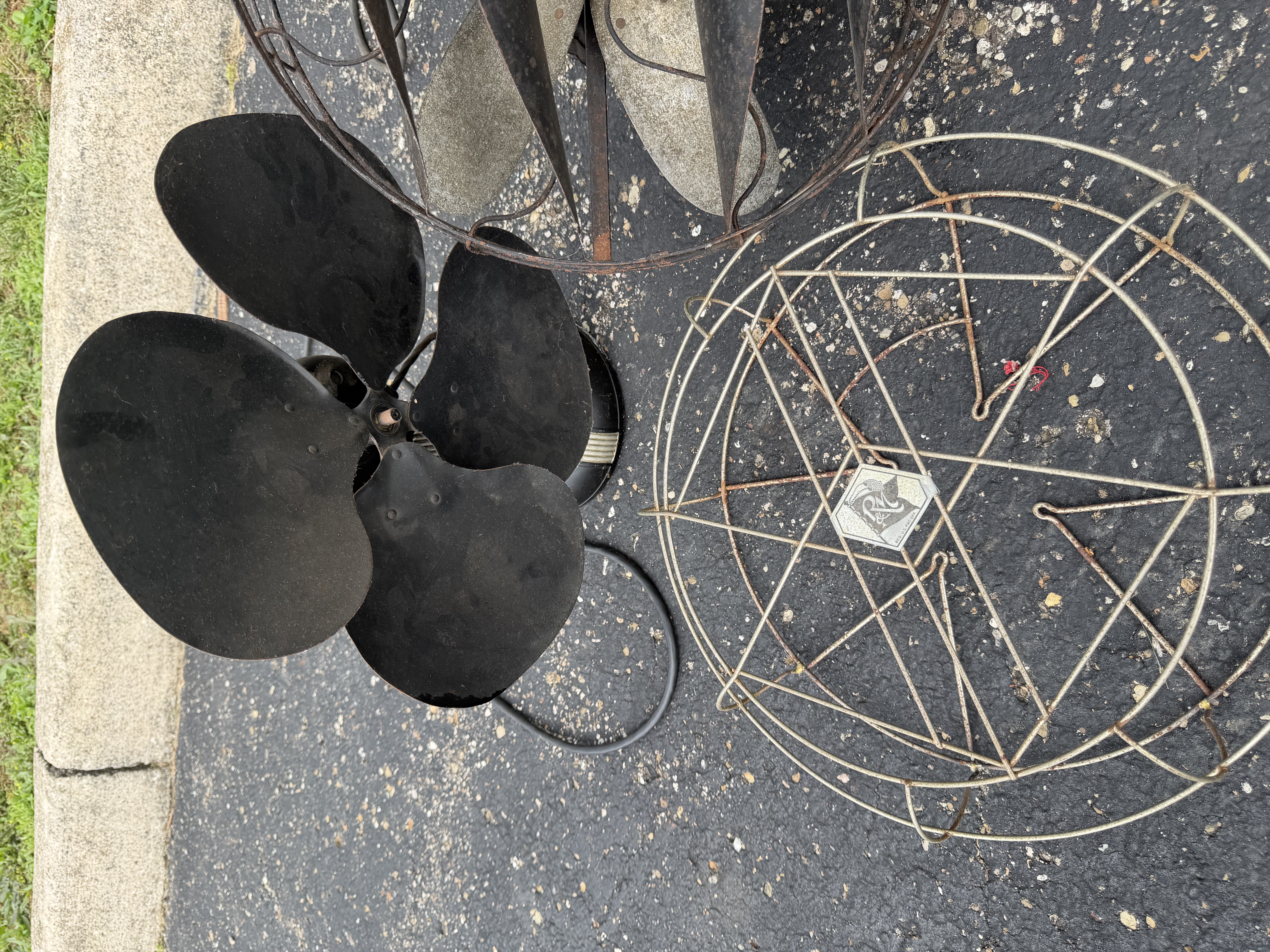 An Assortment of Vintage Electric Desk Fans and Spare Fan Cage