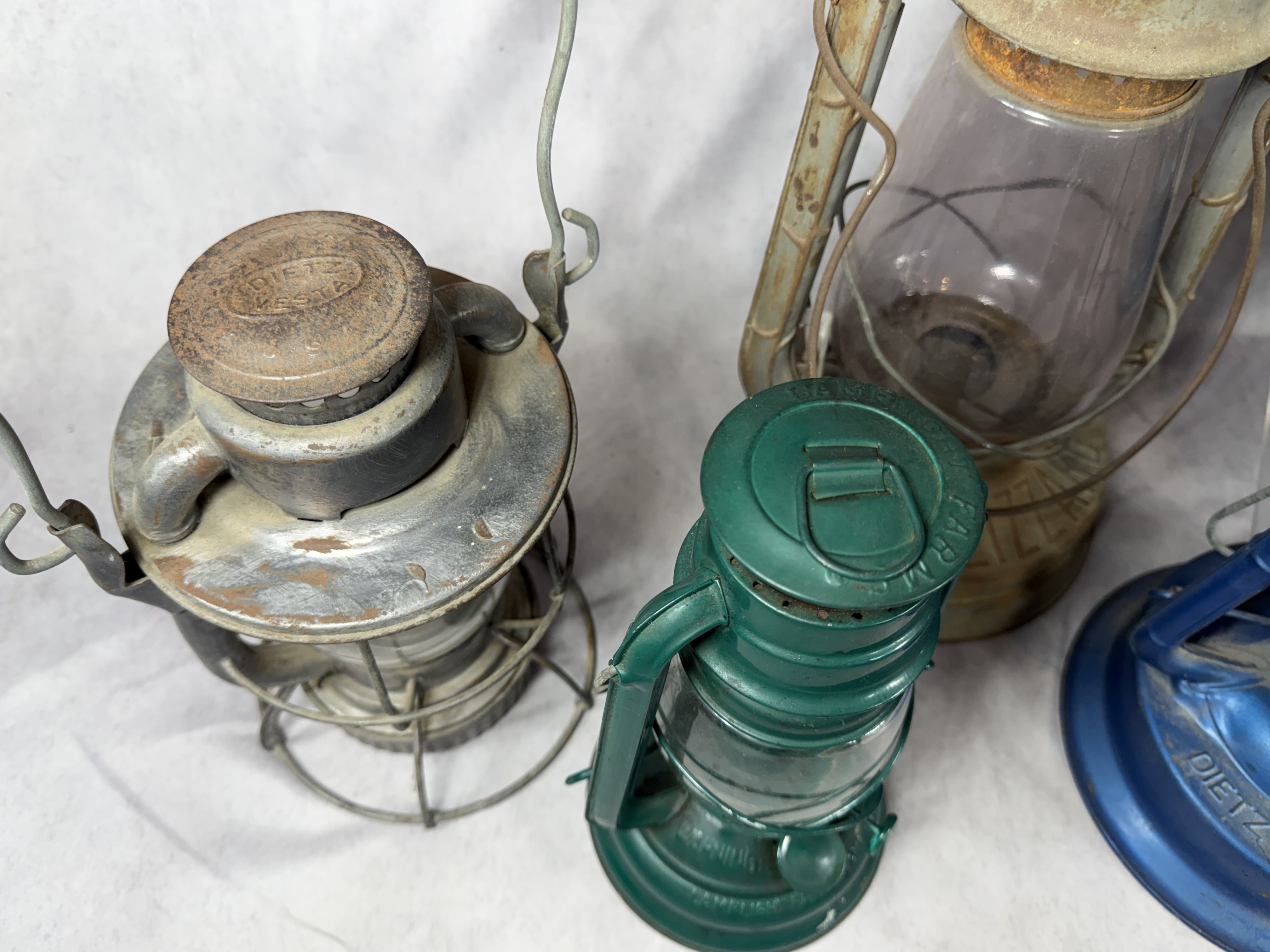 A Collection of Vintage and Contemporary Metal Oil Lanterns Including Dietz and Lamplight Farms