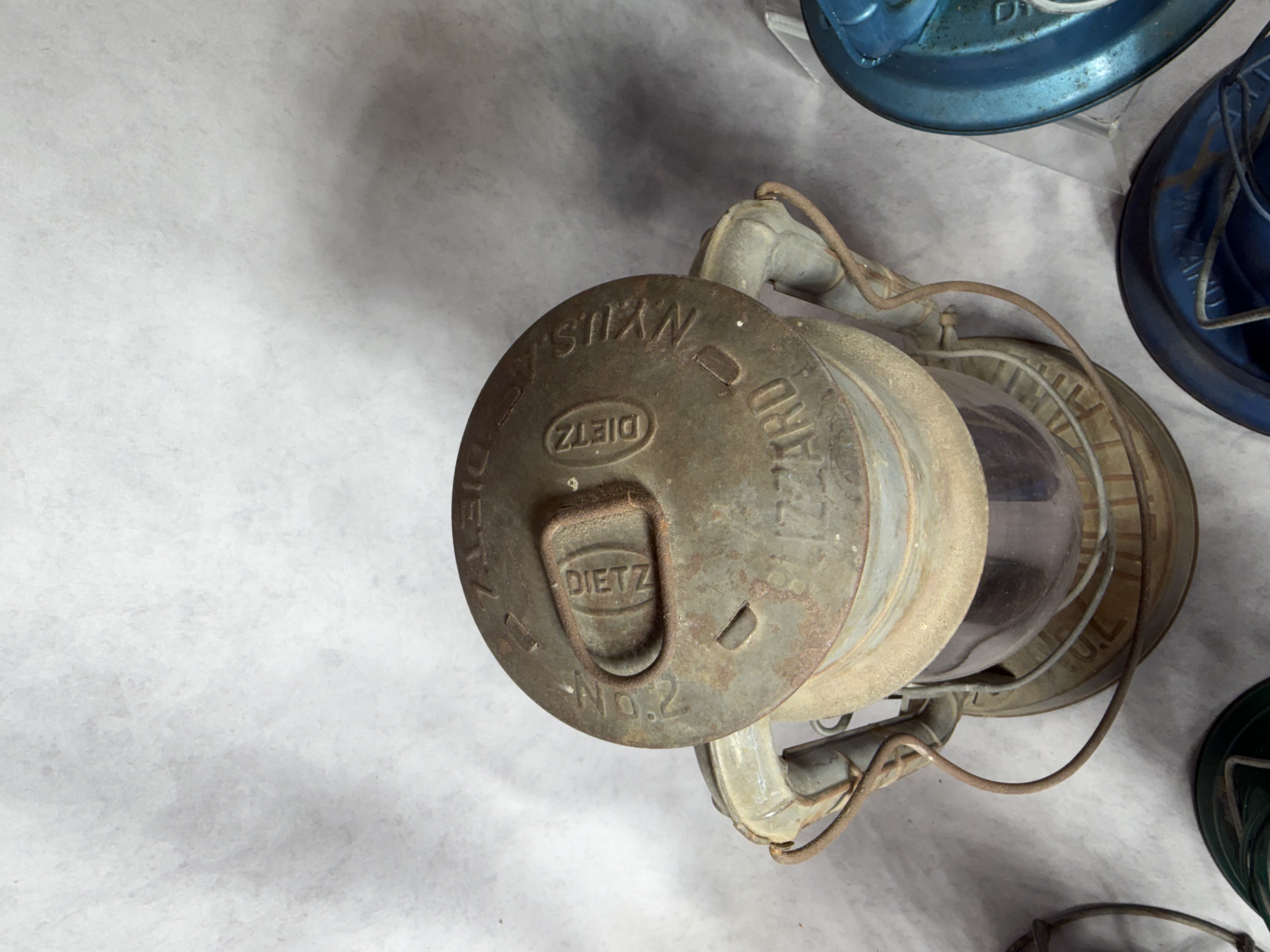 A Collection of Vintage and Contemporary Metal Oil Lanterns Including Dietz and Lamplight Farms