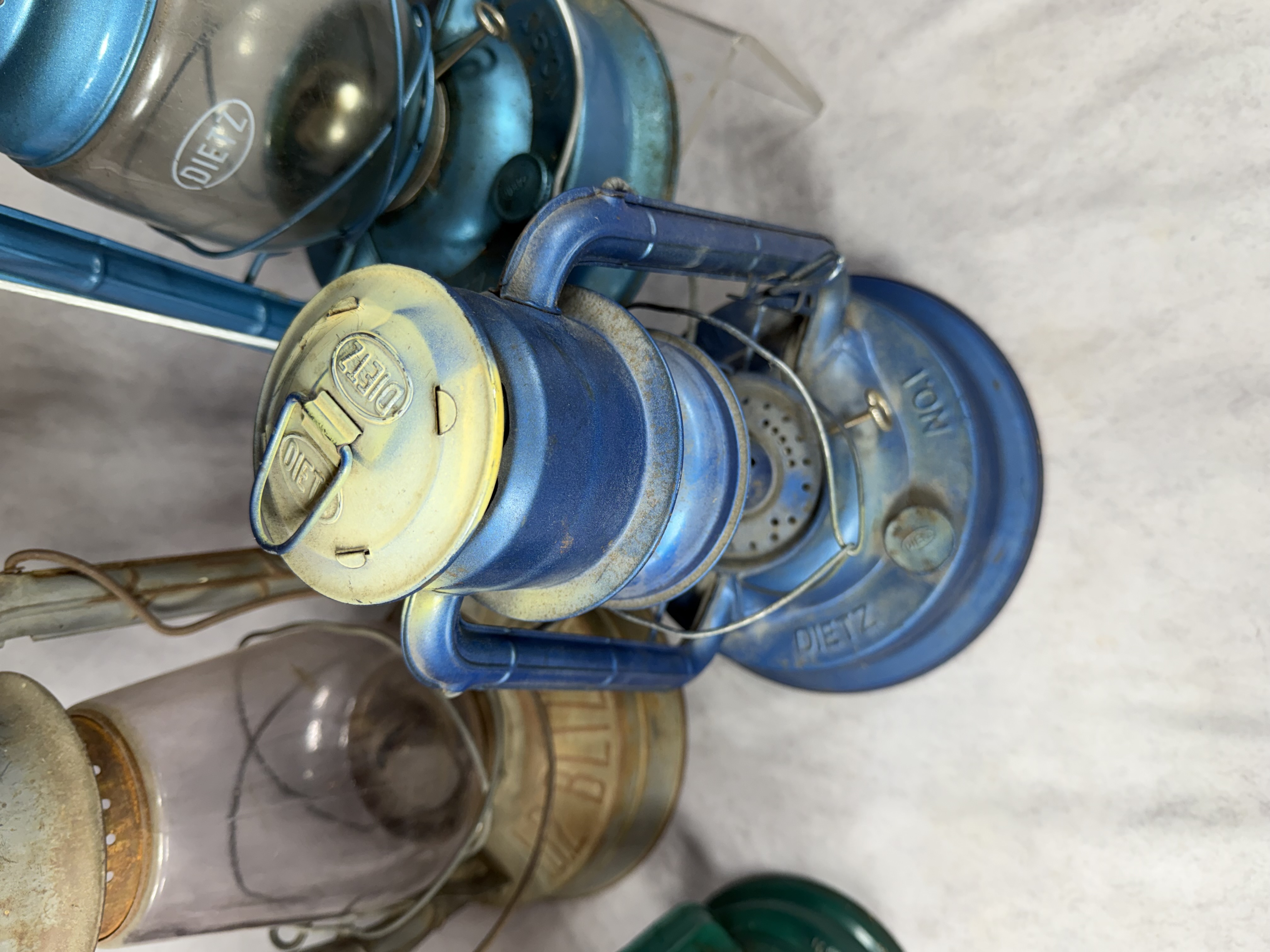 A Collection of Vintage and Contemporary Metal Oil Lanterns Including Dietz and Lamplight Farms