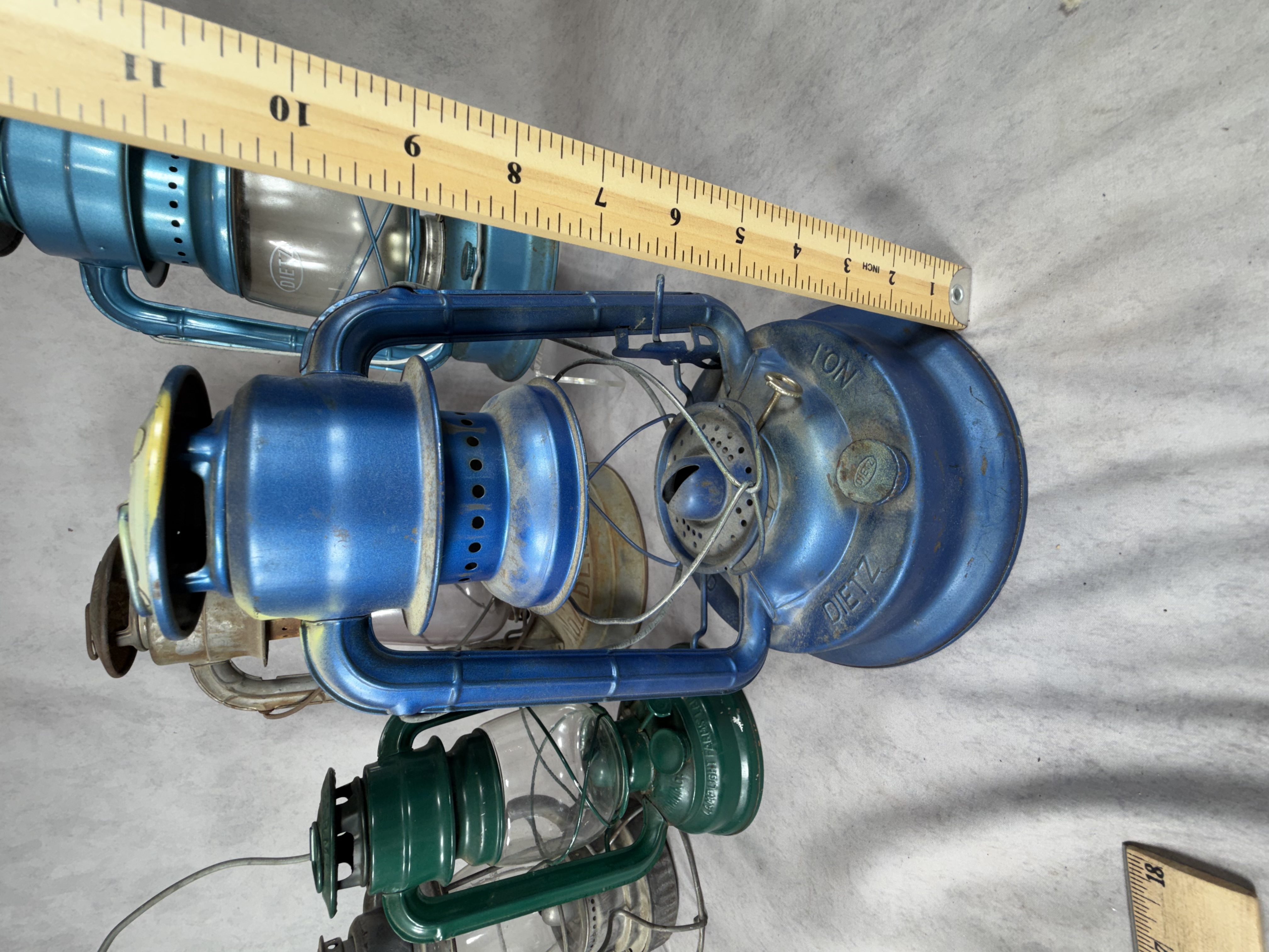 A Collection of Vintage and Contemporary Metal Oil Lanterns Including Dietz and Lamplight Farms