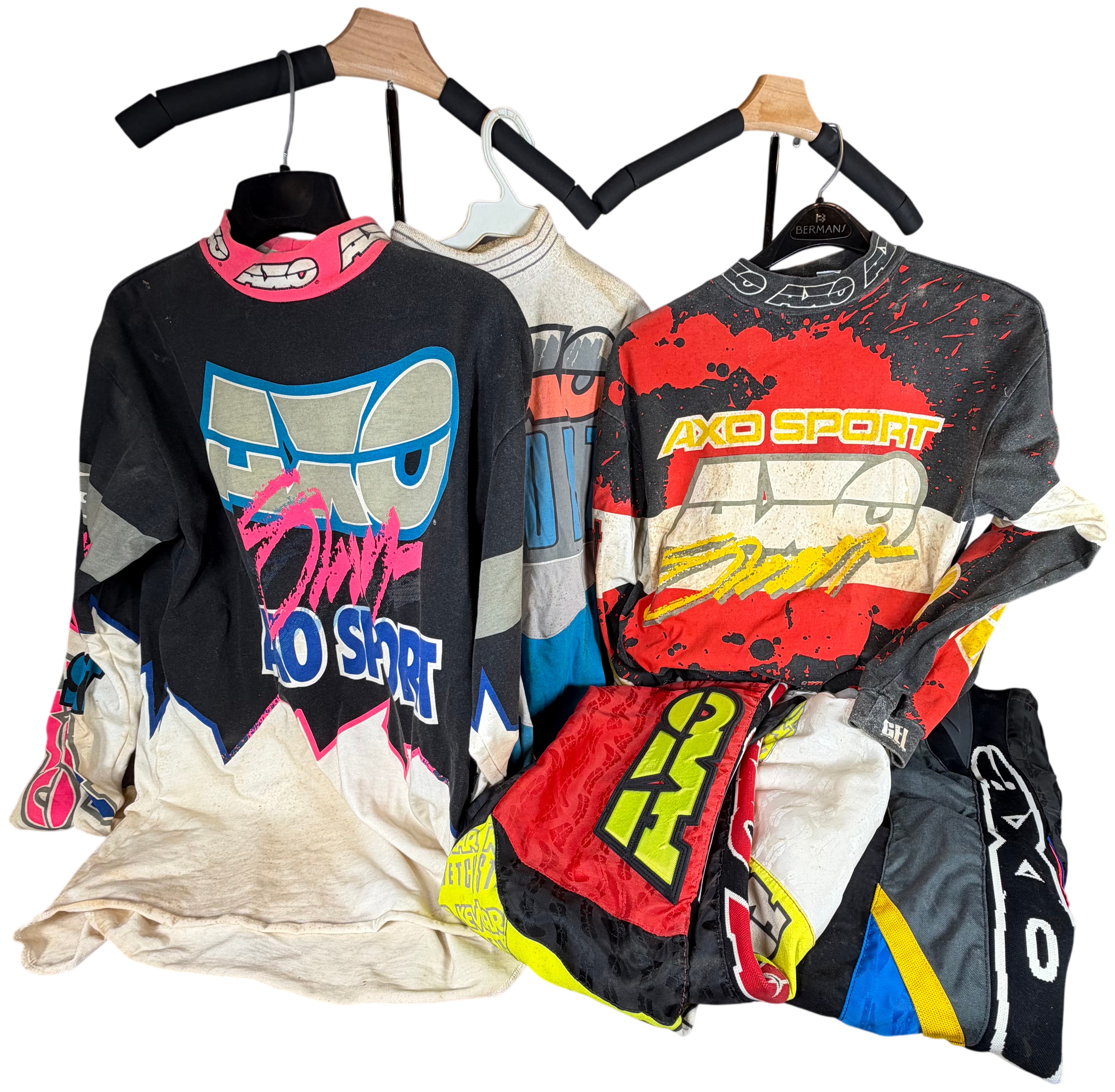 A Collection of Five Vintage AXO Sport Motocross Racing Jerseys and Pants Including Damon Bradshaw Edition Items