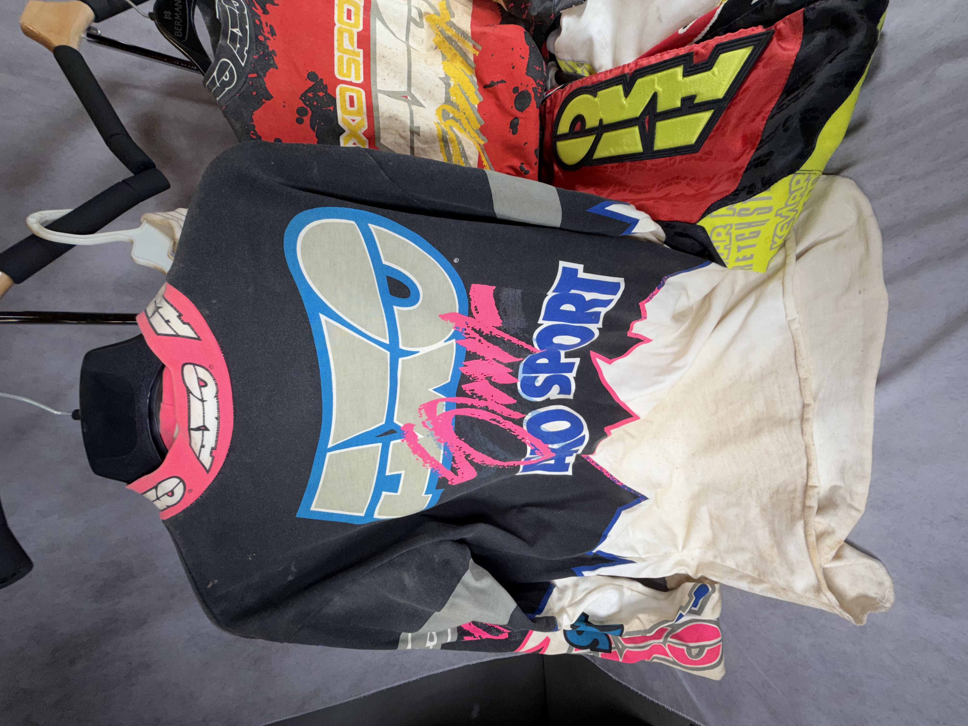 A Collection of Five Vintage AXO Sport Motocross Racing Jerseys and Pants Including Damon Bradshaw Edition Items