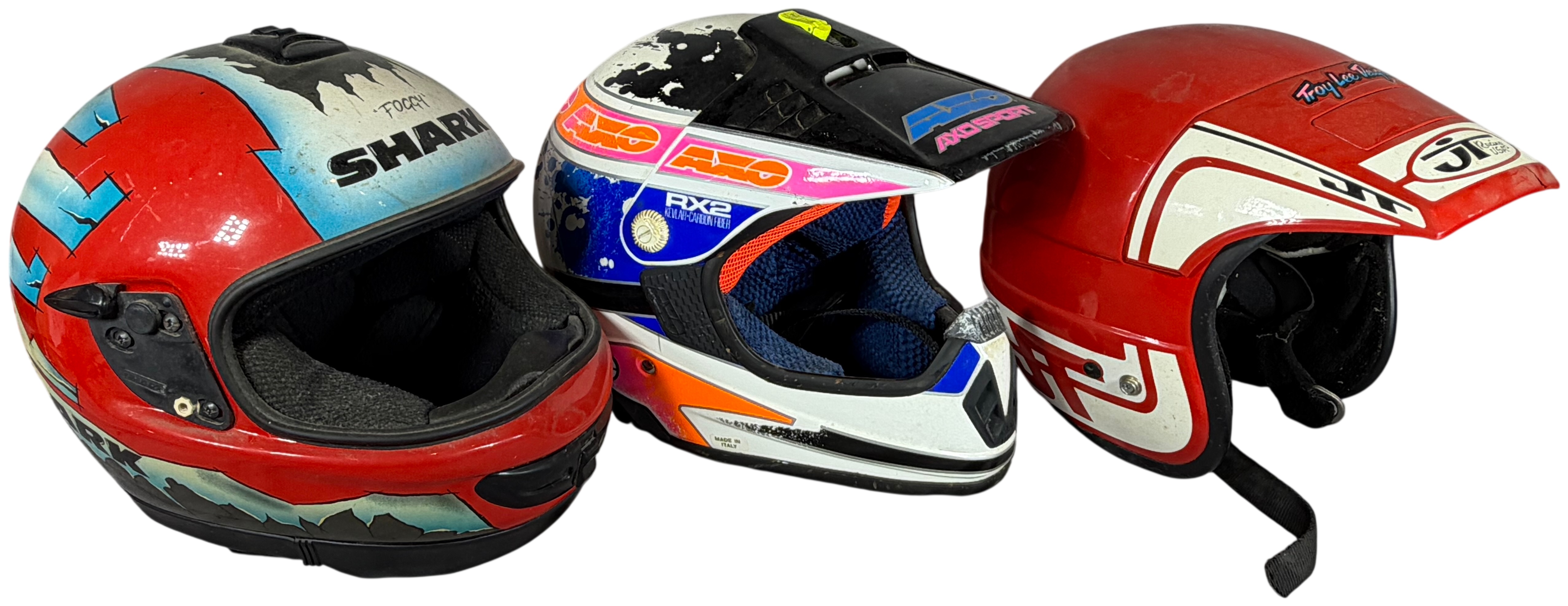 A Trio of Vintage Motorcycle Helmets Including Shark Carl Fogarty Replica, AXO Sport RX2, and Bell JT Racing USA