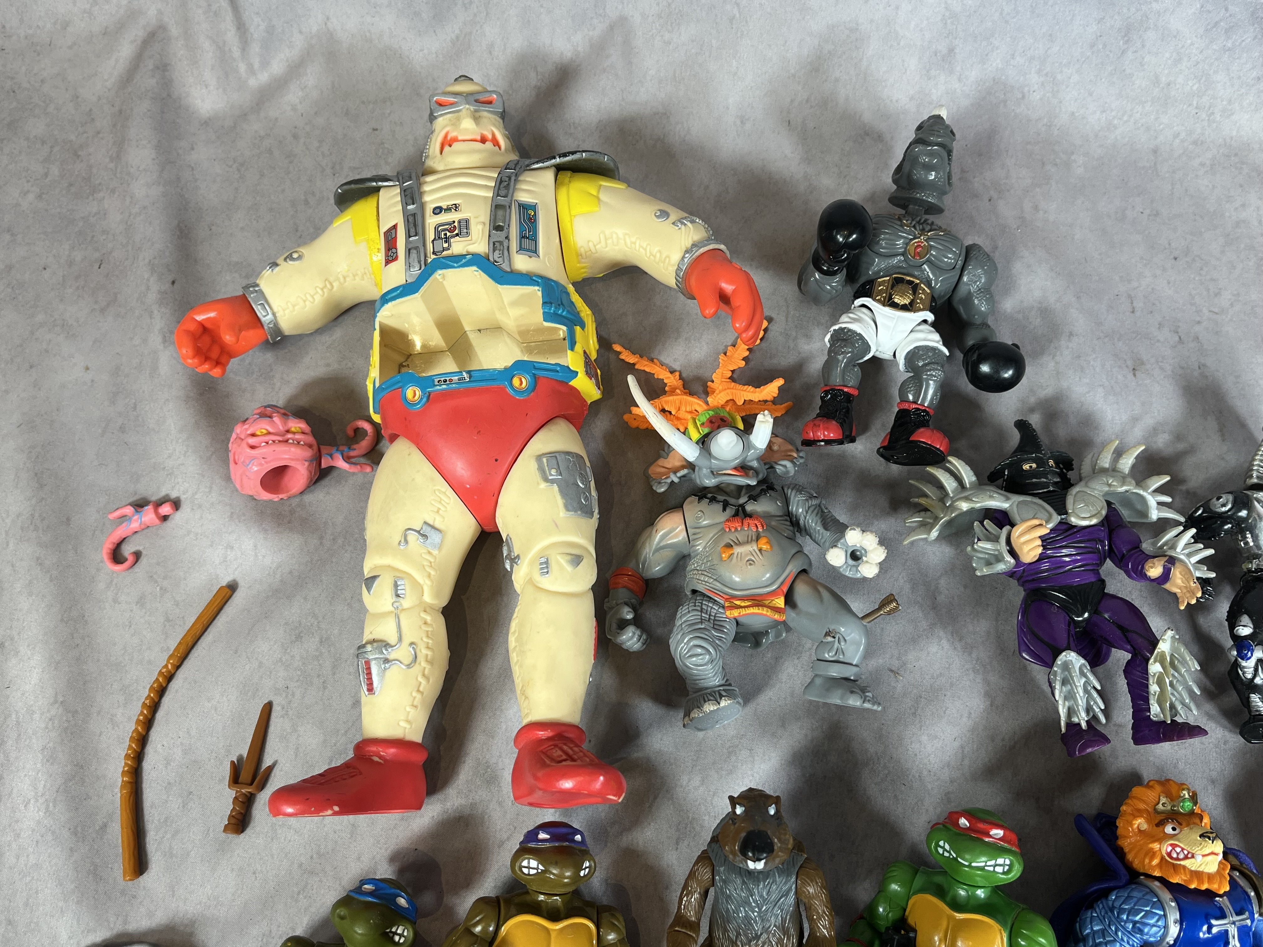 A Collection of Vintage Playmates Teenage Mutant Ninja Turtles Action Figures and Accessories