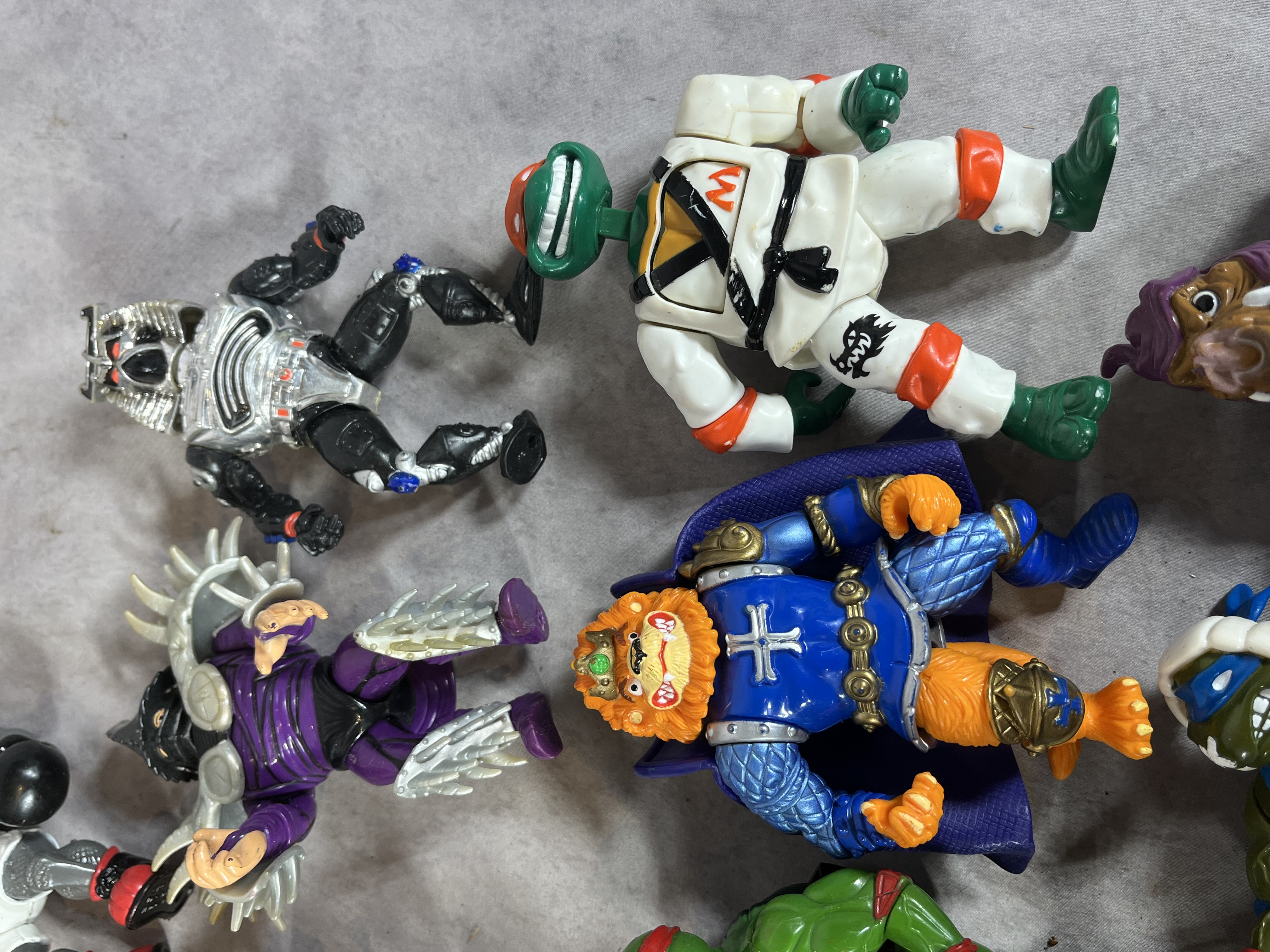 A Collection of Vintage Playmates Teenage Mutant Ninja Turtles Action Figures and Accessories