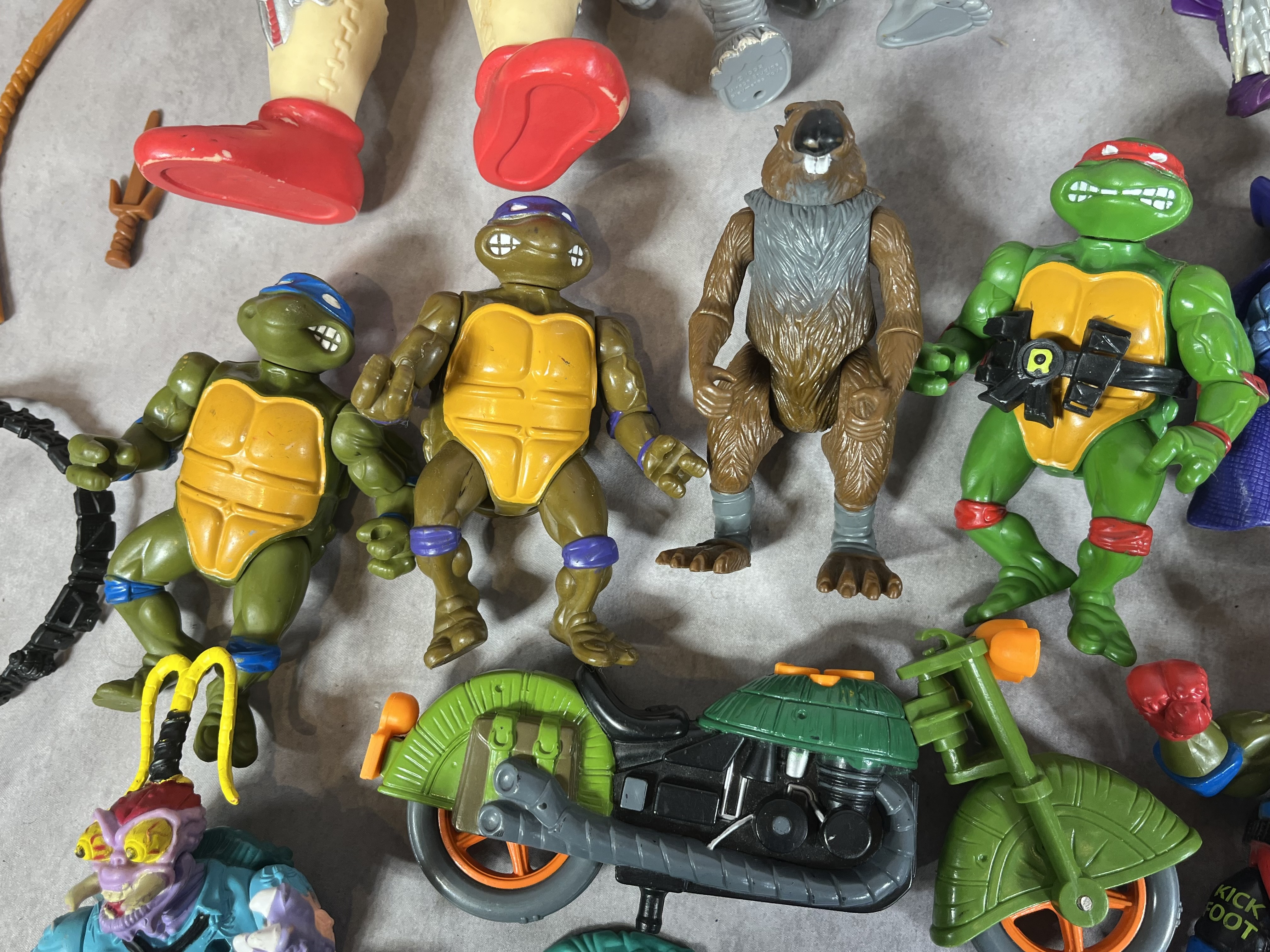 A Collection of Vintage Playmates Teenage Mutant Ninja Turtles Action Figures and Accessories