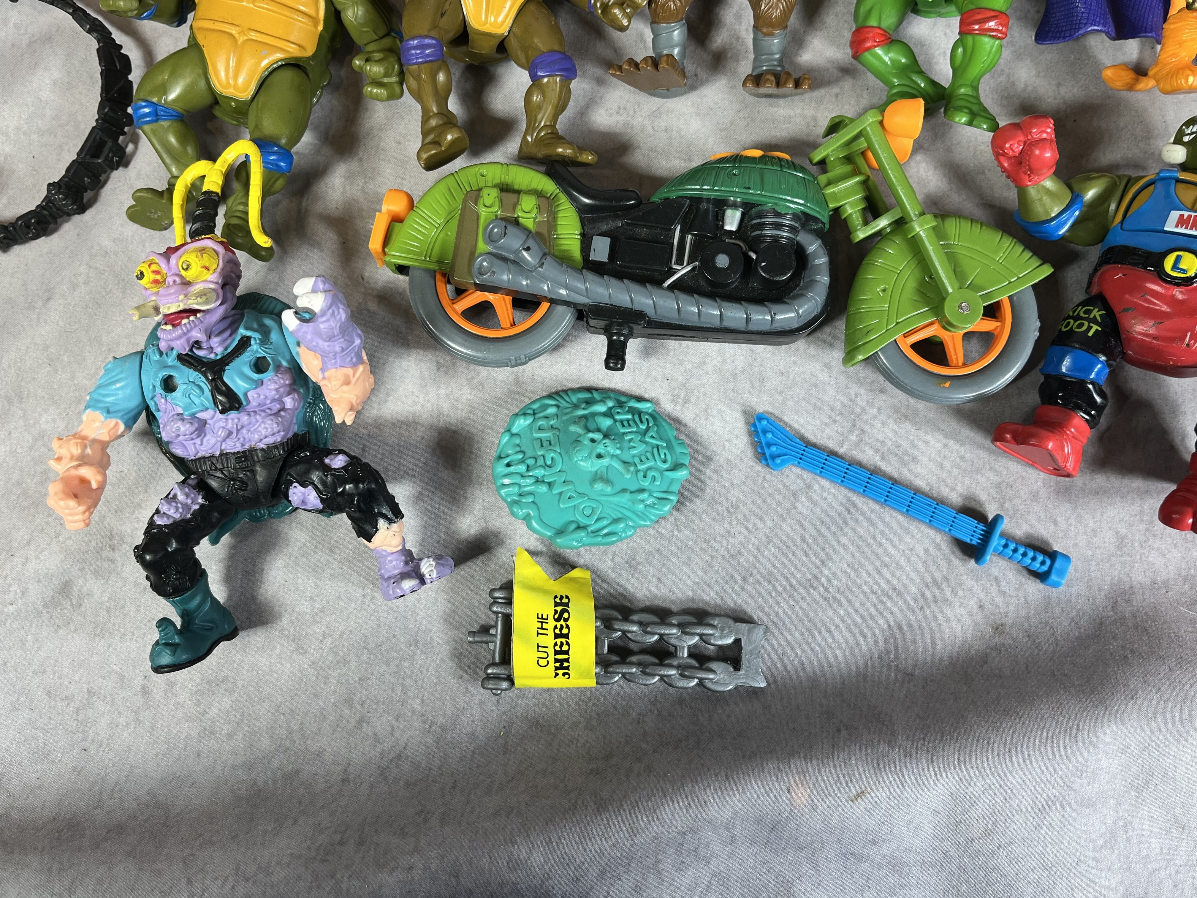A Collection of Vintage Playmates Teenage Mutant Ninja Turtles Action Figures and Accessories