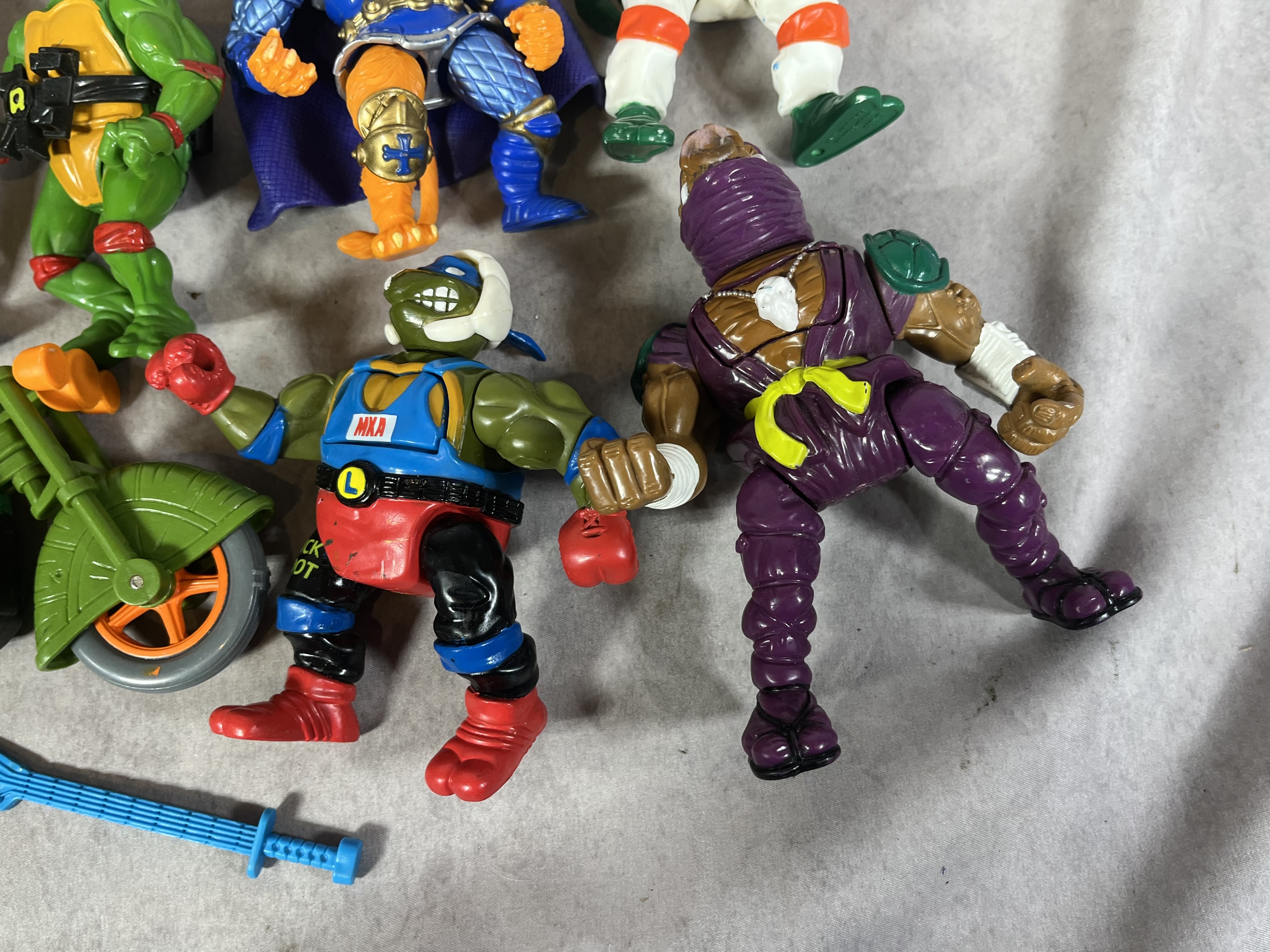 A Collection of Vintage Playmates Teenage Mutant Ninja Turtles Action Figures and Accessories