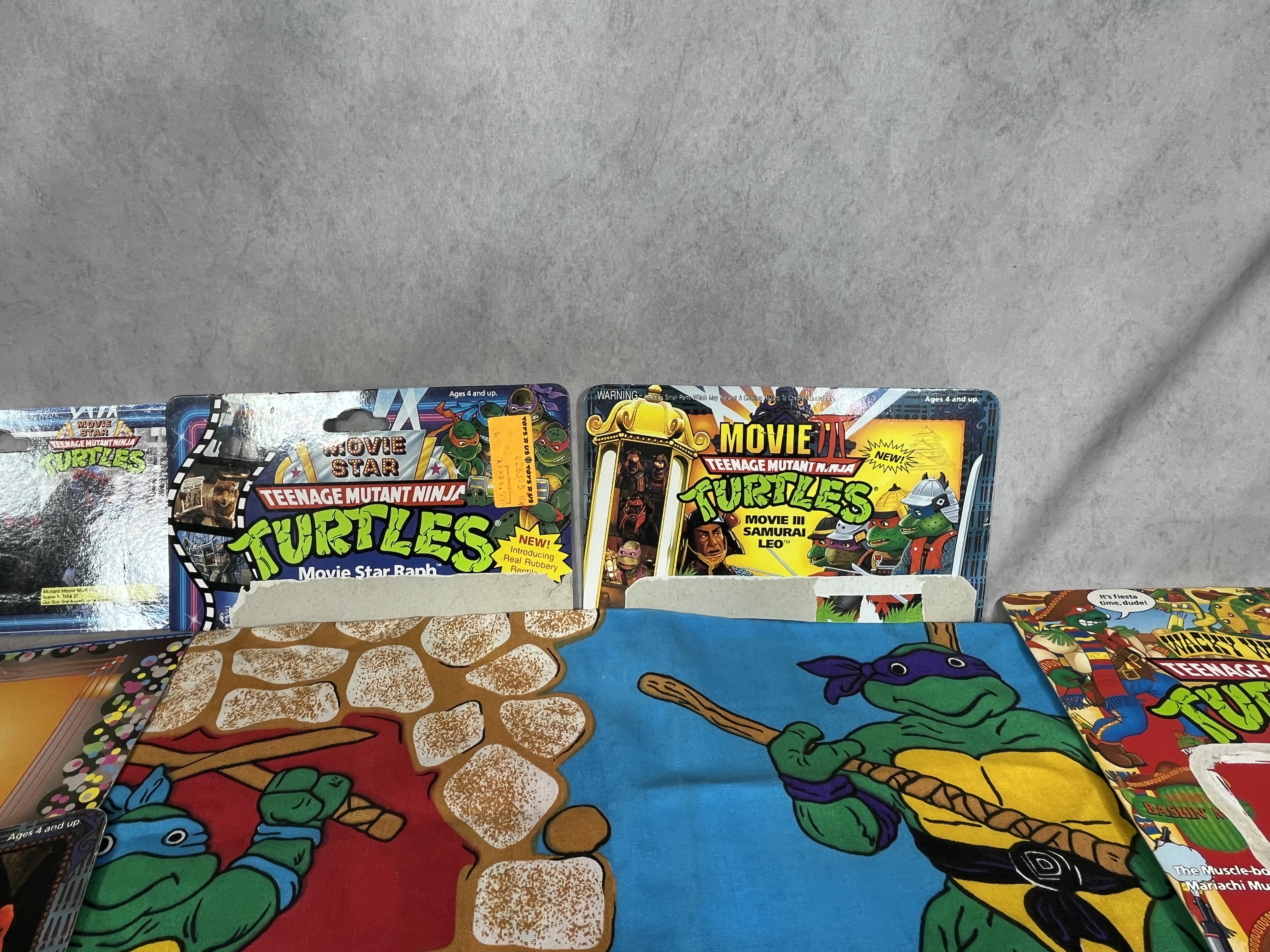 A Collection of Vintage Teenage Mutant Ninja Turtles Action Figures and Memorabilia by Playmates and Random House
