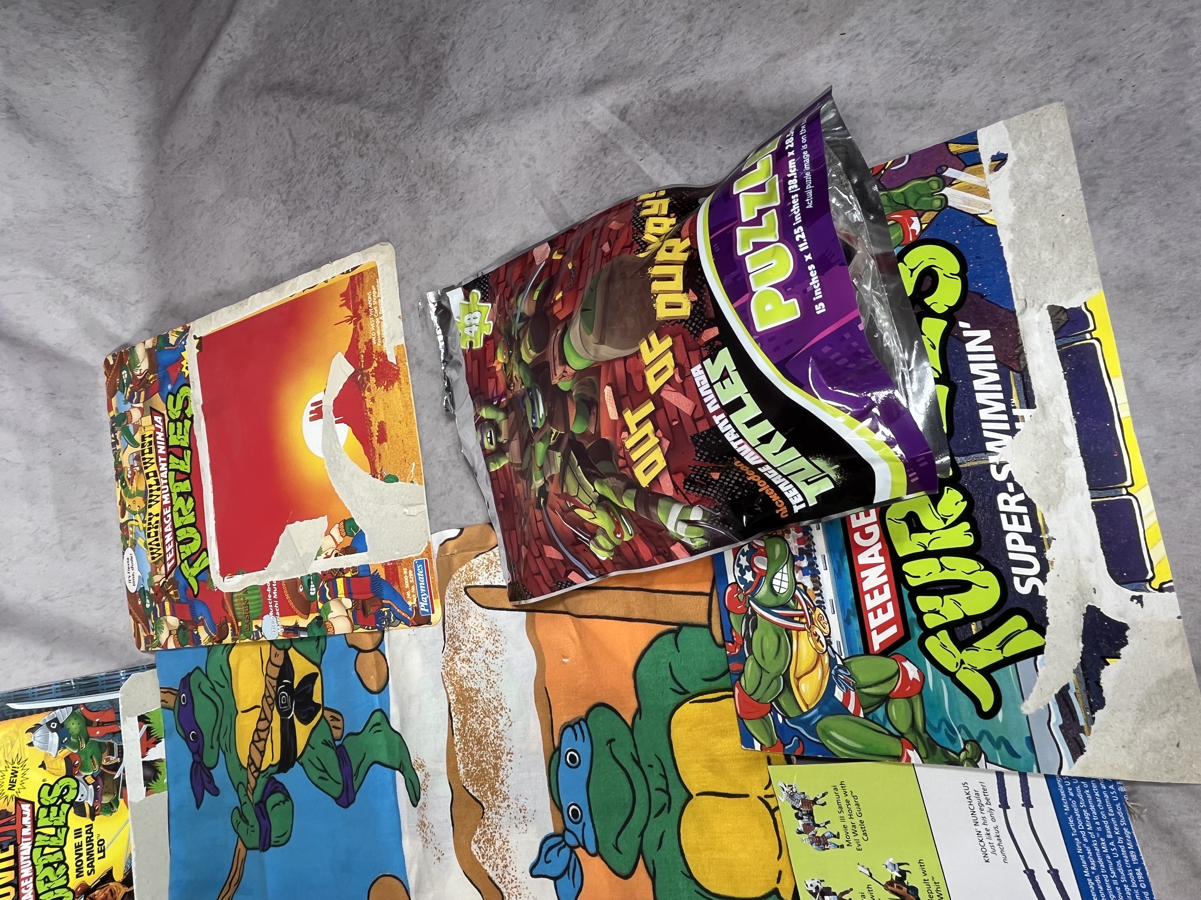 A Collection of Vintage Teenage Mutant Ninja Turtles Action Figures and Memorabilia by Playmates and Random House