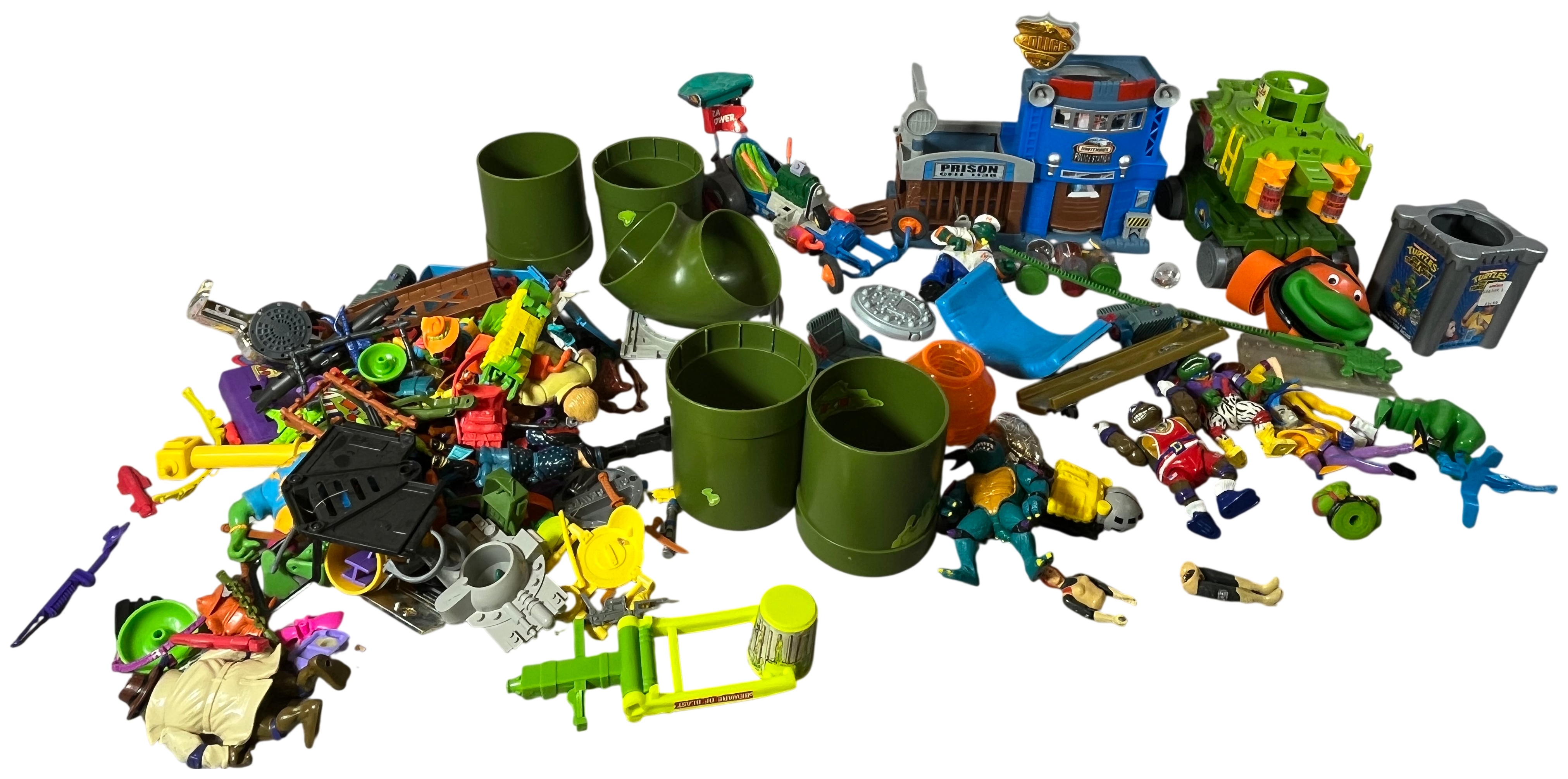 An Assortment of Vintage Teenage Mutant Ninja Turtles Action Figures, Vehicles, and Play-set Components by Playmates and Matchbox