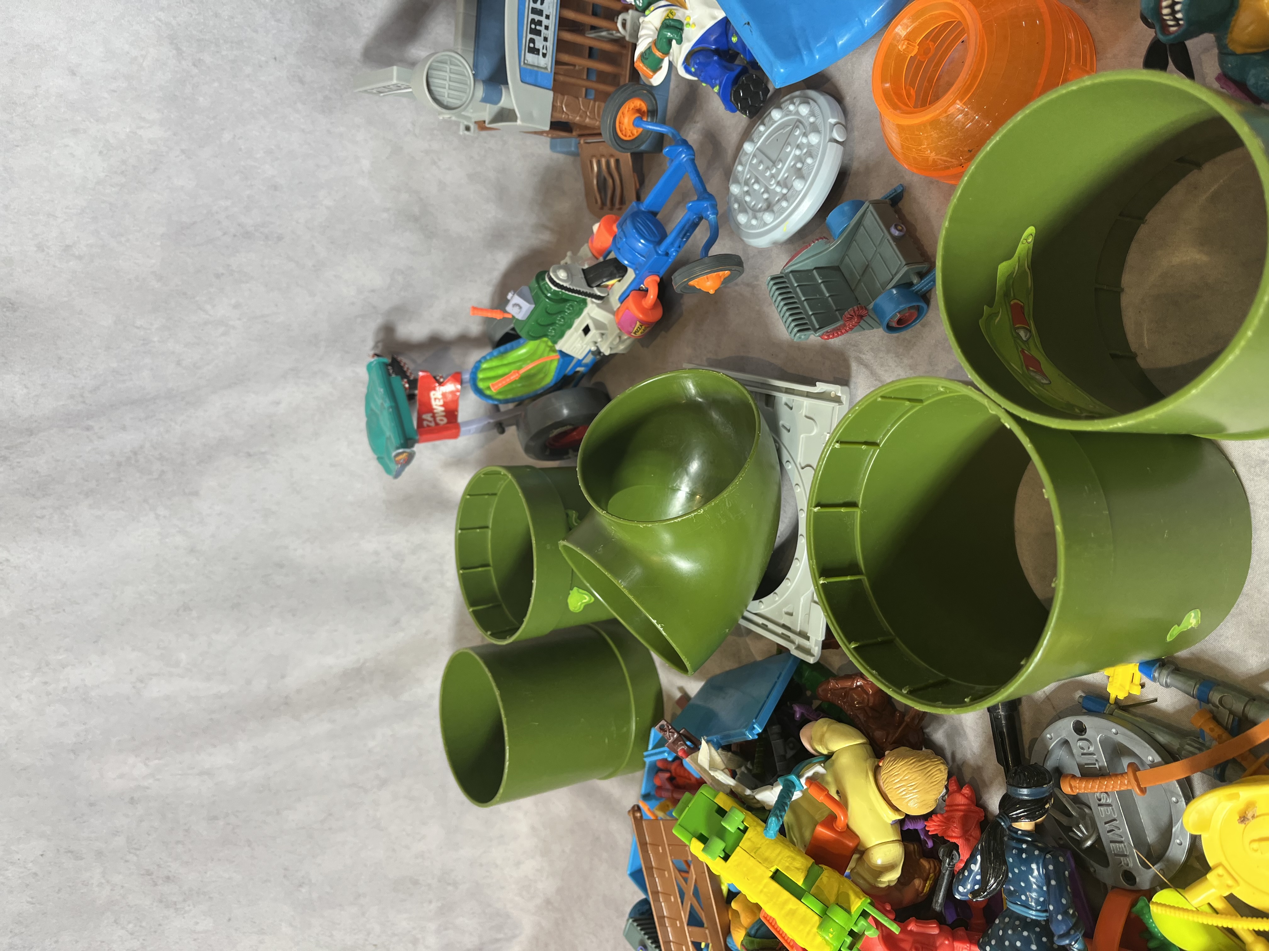 An Assortment of Vintage Teenage Mutant Ninja Turtles Action Figures, Vehicles, and Play-set Components by Playmates and Matchbox