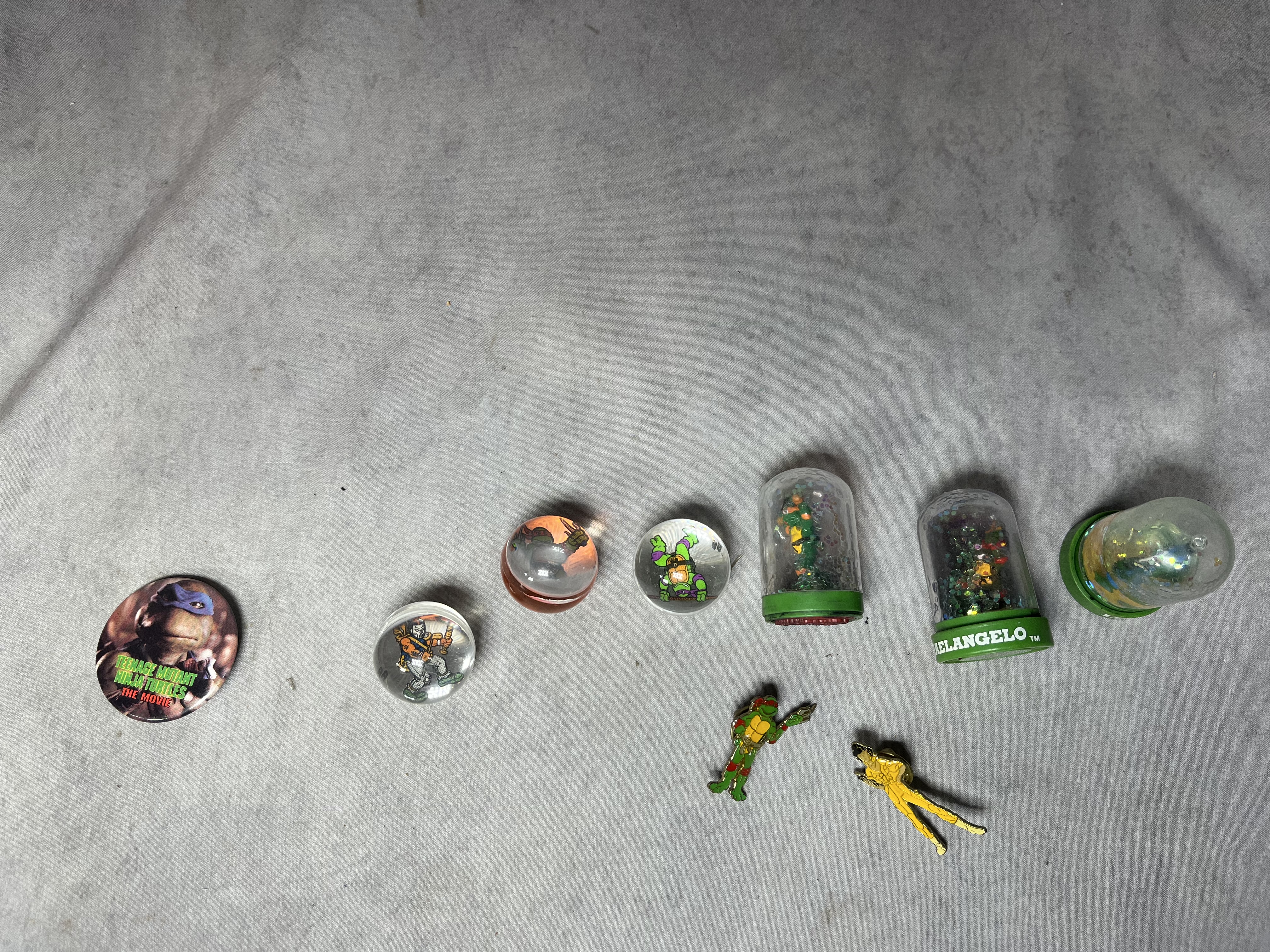An Assortment of Vintage Teenage Mutant Ninja Turtles Action Figures, Vehicles, and Play-set Components by Playmates and Matchbox