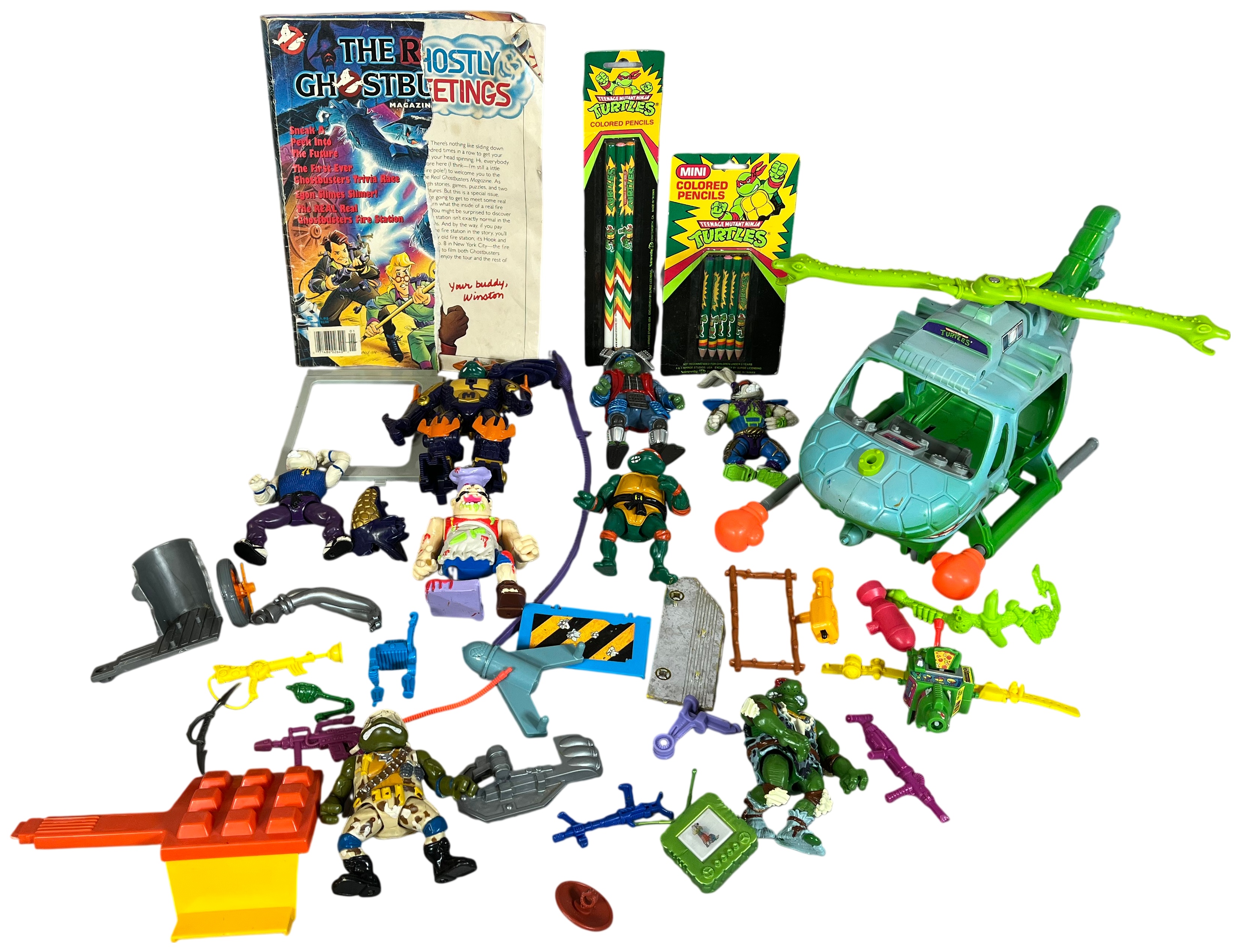 A Collection of Vintage Teenage Mutant Ninja Turtles Playmates Toys Action Figures, Vehicles, and Real Ghostbusters Ephemera