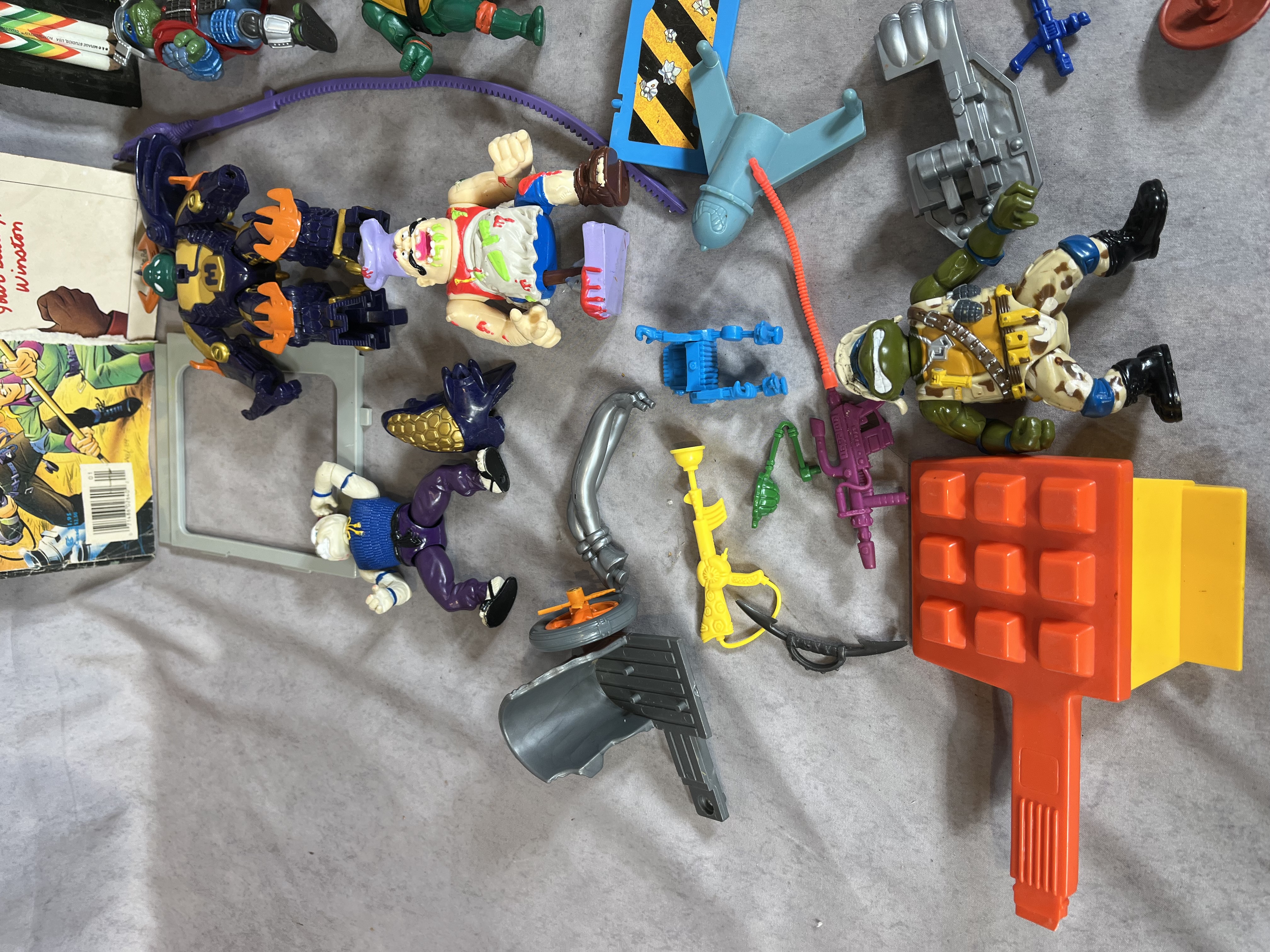 A Collection of Vintage Teenage Mutant Ninja Turtles Playmates Toys Action Figures, Vehicles, and Real Ghostbusters Ephemera