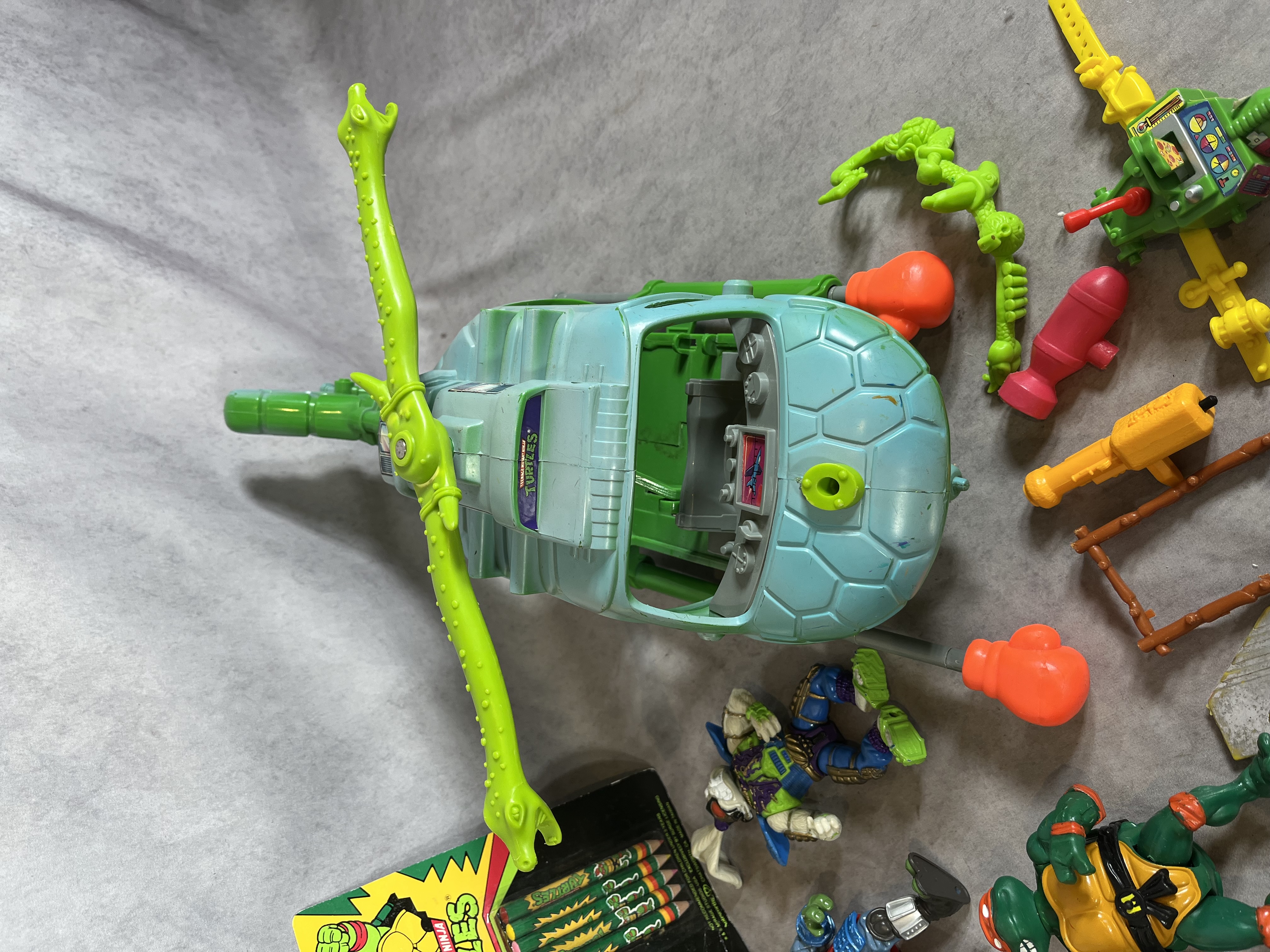 A Collection of Vintage Teenage Mutant Ninja Turtles Playmates Toys Action Figures, Vehicles, and Real Ghostbusters Ephemera