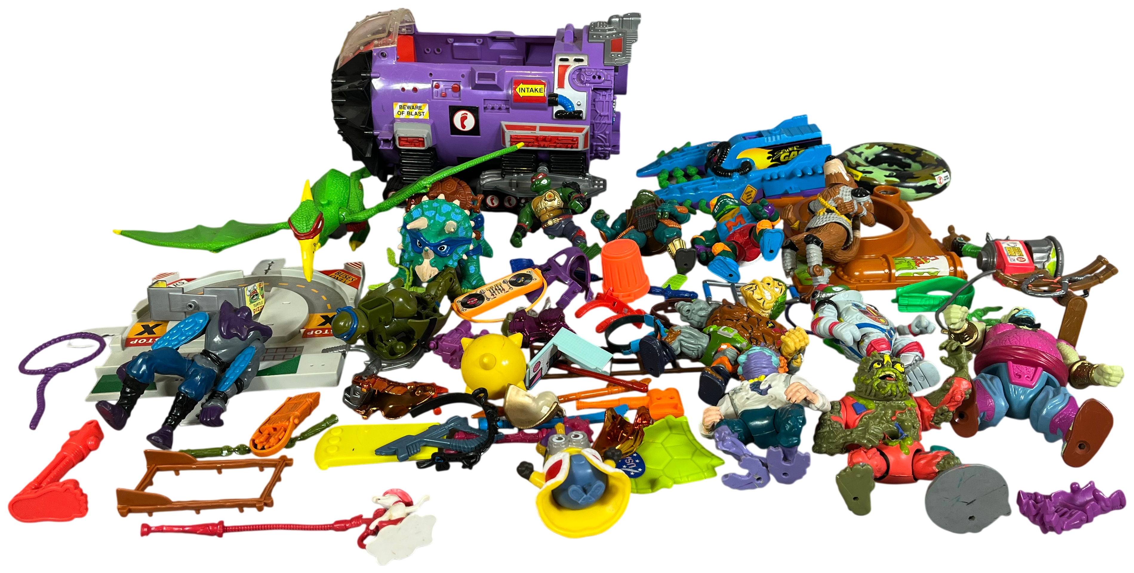 A Collection of Vintage Teenage Mutant Ninja Turtles Action Figures and Vehicles by Playmates