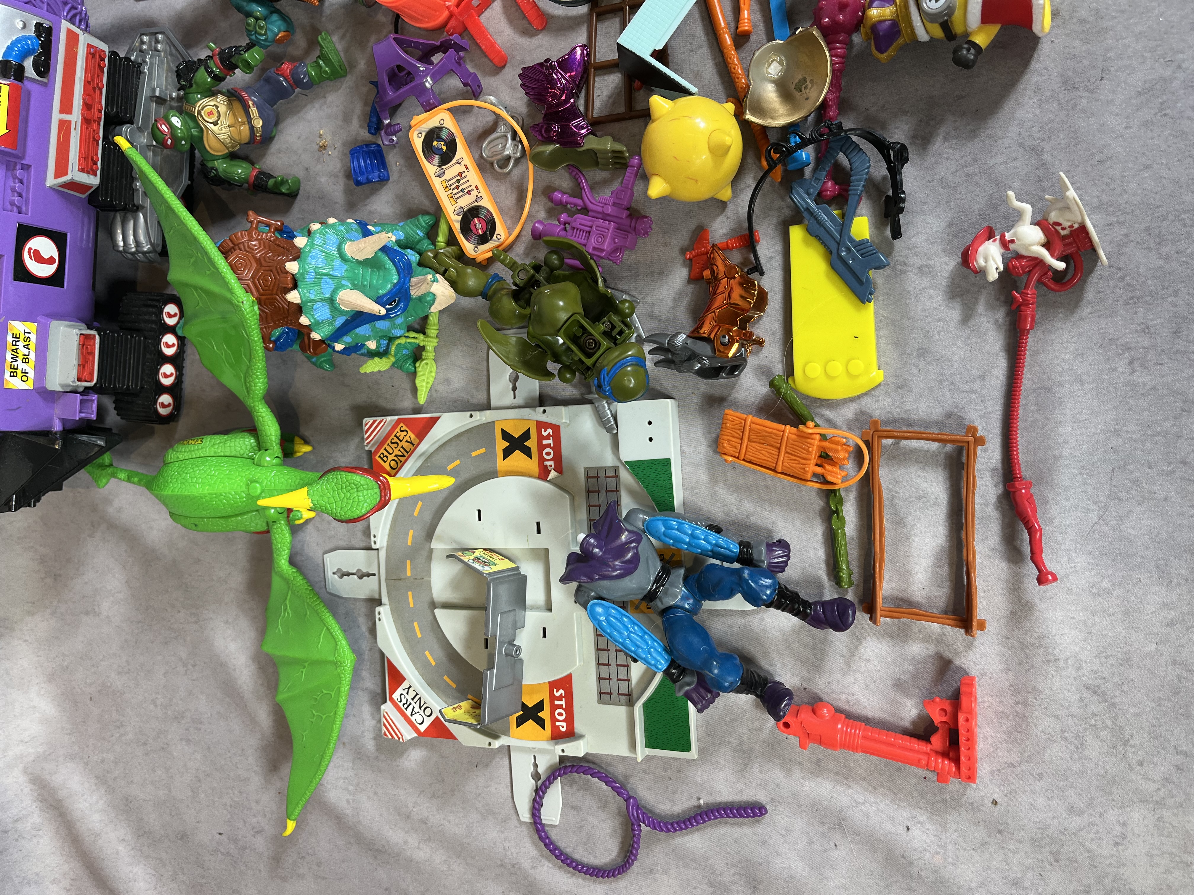 A Collection of Vintage Teenage Mutant Ninja Turtles Action Figures and Vehicles by Playmates