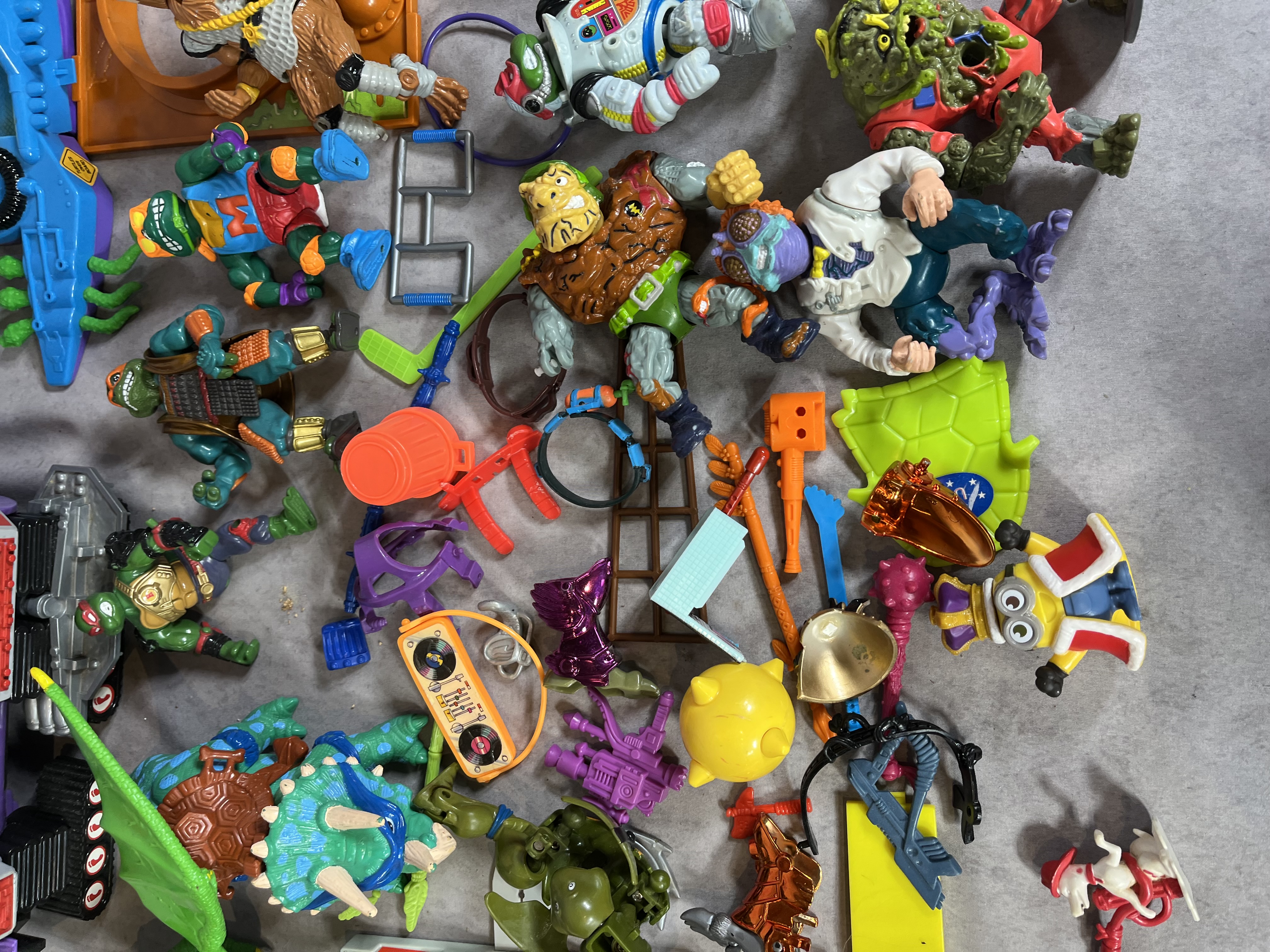 A Collection of Vintage Teenage Mutant Ninja Turtles Action Figures and Vehicles by Playmates